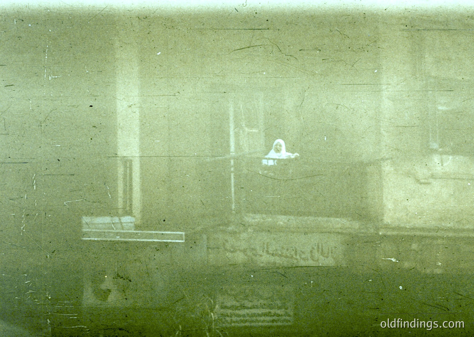 Vintage train window view showing blurred interior with faint graffiti: "Farewell" and a small figure seated. Likely mid-20th century European railway car (, , , , )