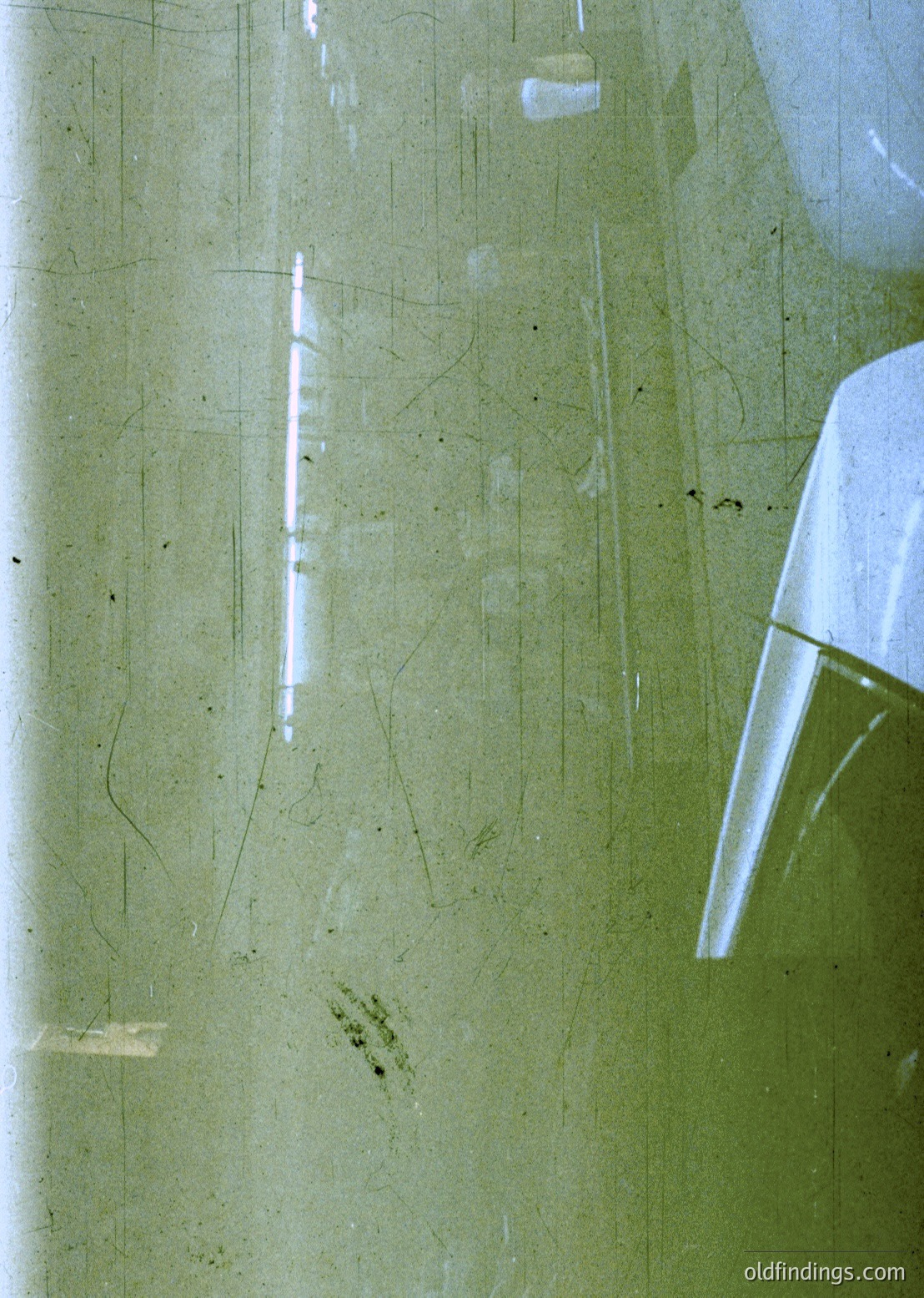 Vintage green enamel sink with visible age marks, cracks, and minor staining. Mid-century industrial or institutional design, likely from the 1950s–1970s. Functional yet worn, reflecting utilitarian aesthetics.