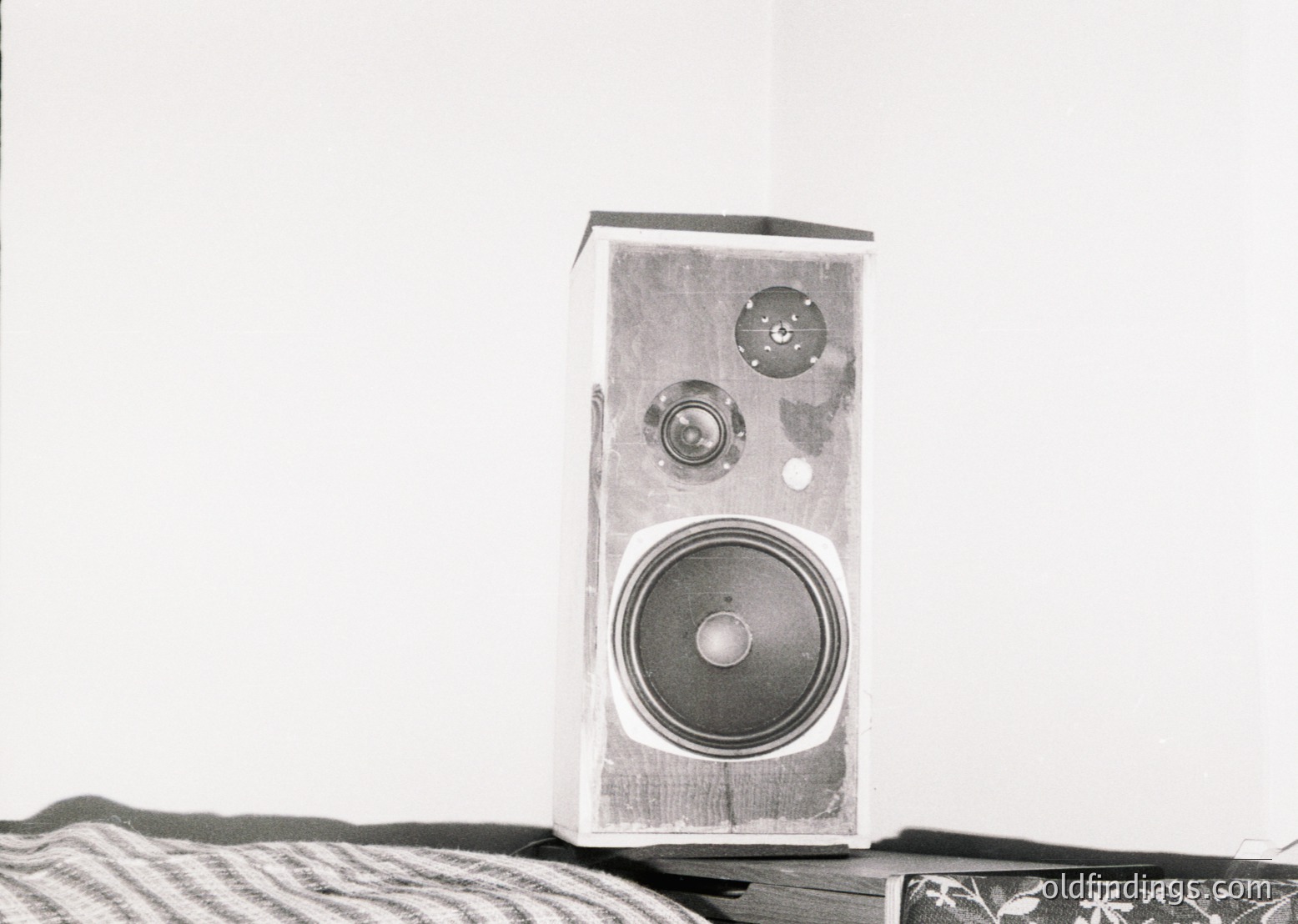 Vintage wooden speaker with dual circular knobs and single large woofer, likely mid-20th century. Clean lines and minimalist design reflect 1950s–1960s home audio aesthetics.