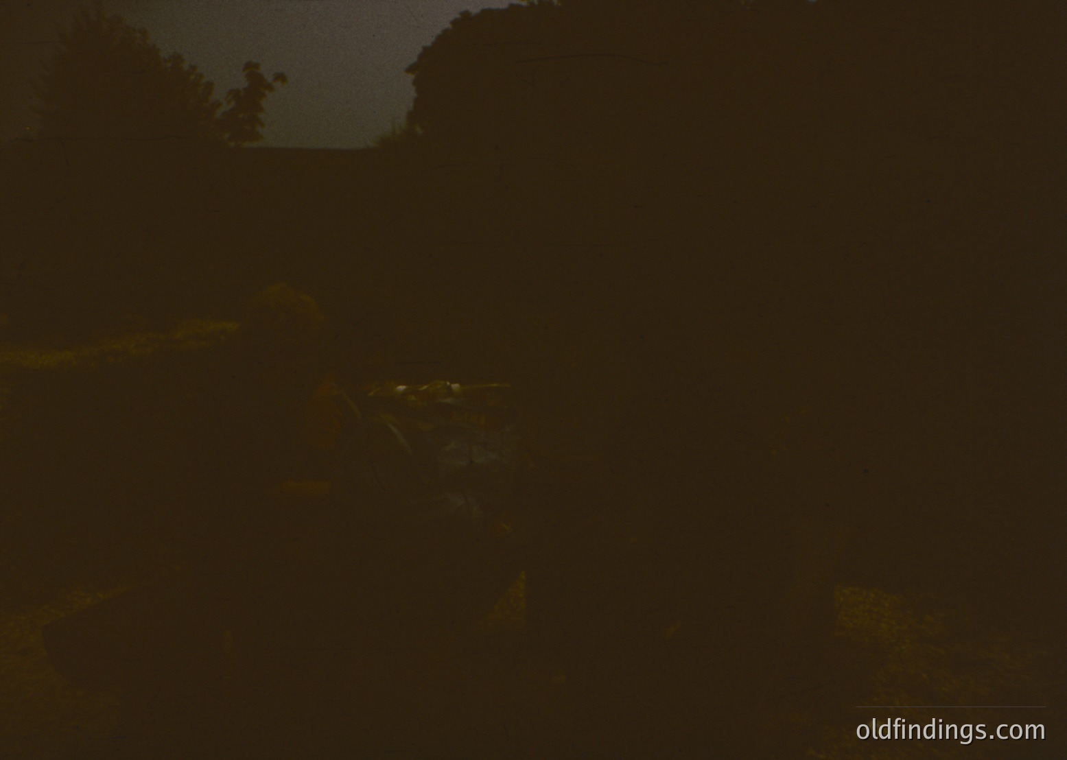 Low-contrast black-and-white nighttime shot of a **mountainous landscape** with faint outlines of rocky ridges and a distant valley. Minimal detail prevents precise identification, but suggests **alpine terrain** under starlit skies. Potential for atmospheric or moody stock imagery.