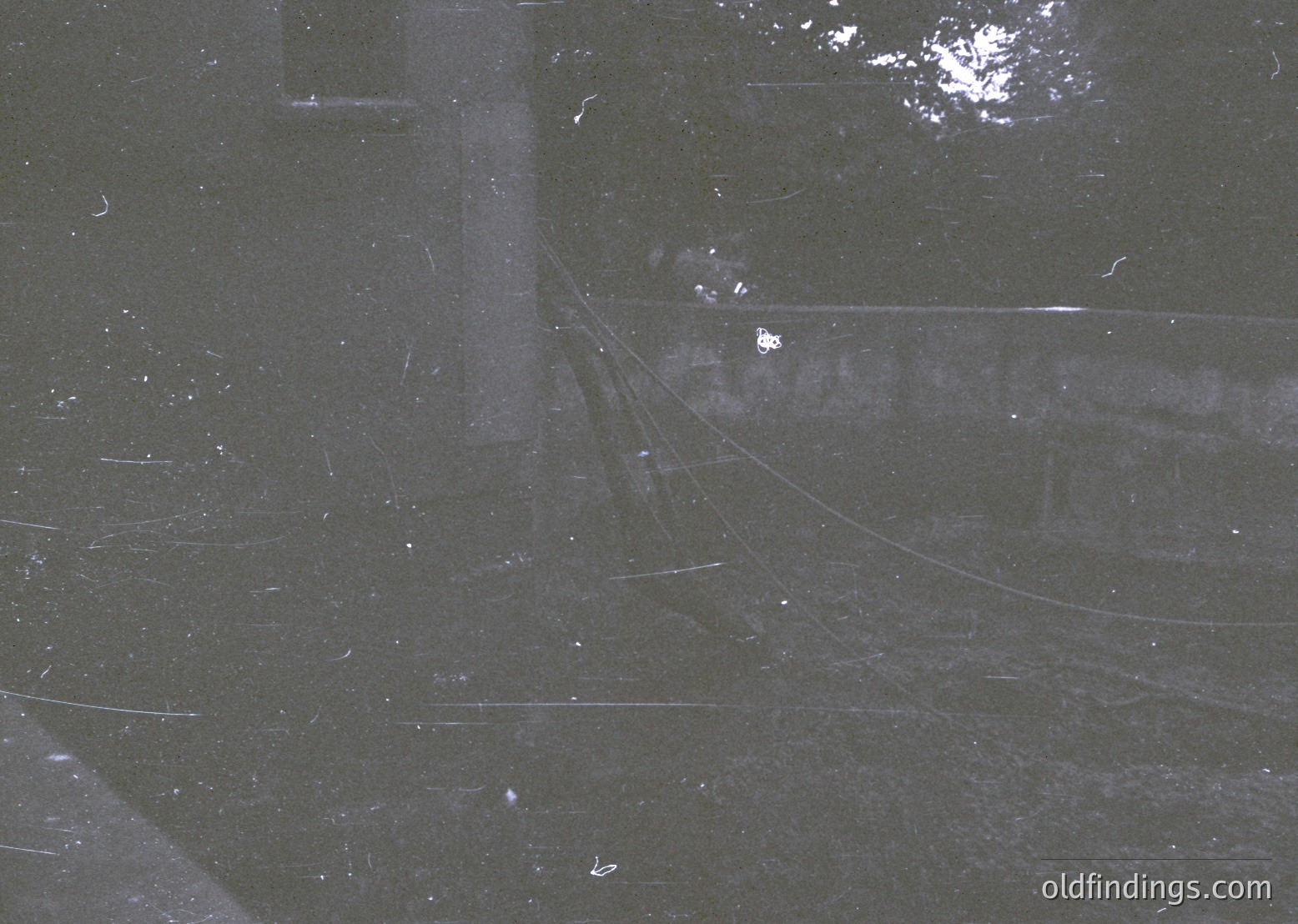 Aerial view of a densely packed urban grid, likely from a 1960s–1980s satellite or reconnaissance photo. Regularly spaced streets form a geometric pattern, with visible road curves and intersections. Darker areas suggest residential or industrial zones. Minimal greenery or landmarks visible.