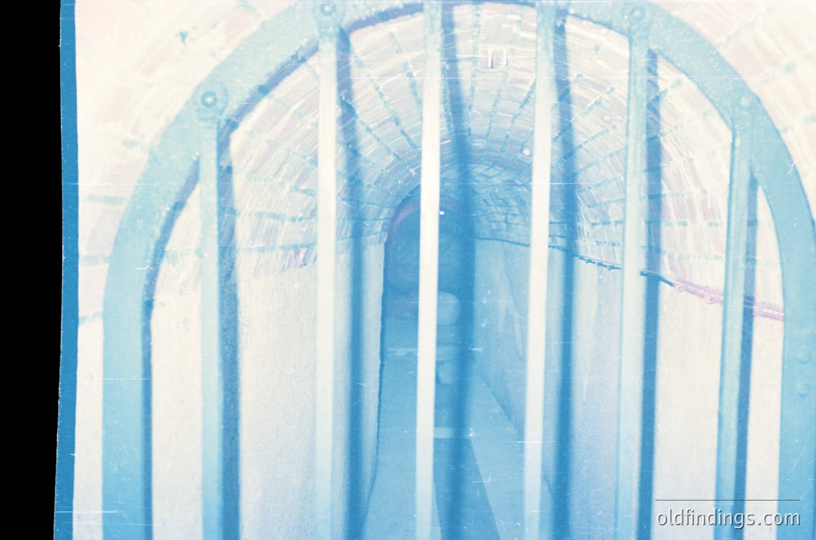 Vintage architectural blueprint overlaying a curved structural design, likely a bridge or arch. The translucent tracing suggests mid-20th century engineering drafts ( ).