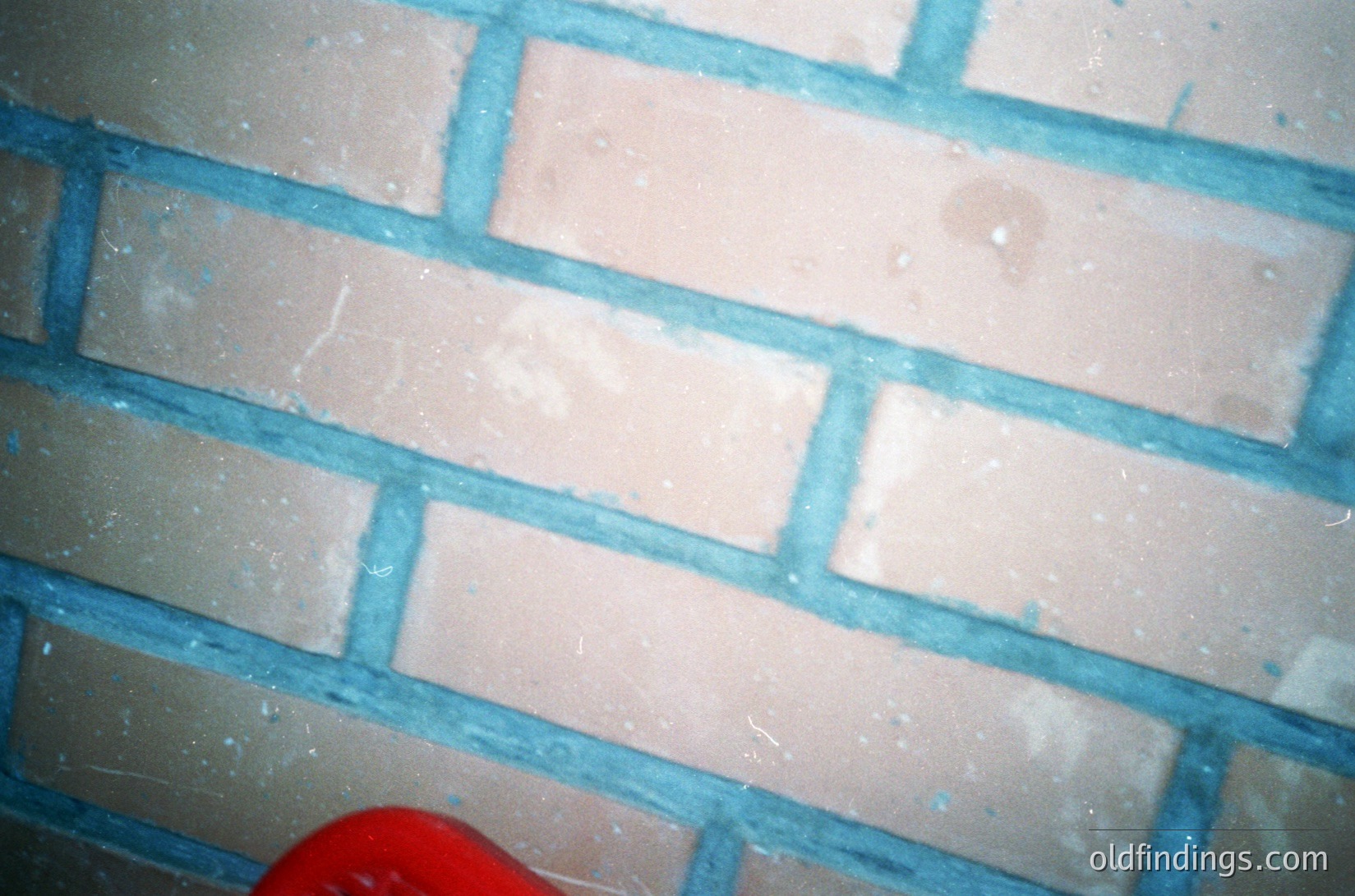 Close-up of **1970s-era Soviet-style ceramic wall tiles** featuring **blue grout lines** and **off-white glazed surfaces**, likely from a public building or apartment. Distinctive **rectangular pattern** with slight discoloration marks.