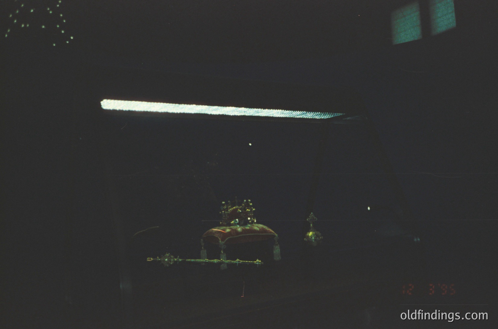 Vintage film grain overlay of a dimly lit indoor scene with a neon sign and decorative Christmas tree elements. The blurred, monochromatic tone suggests 1970s–1980s photography. Neon glow and holiday decor hint at festive commercial or residential interior. Ideal for retro-themed design or nostalgic stock references.