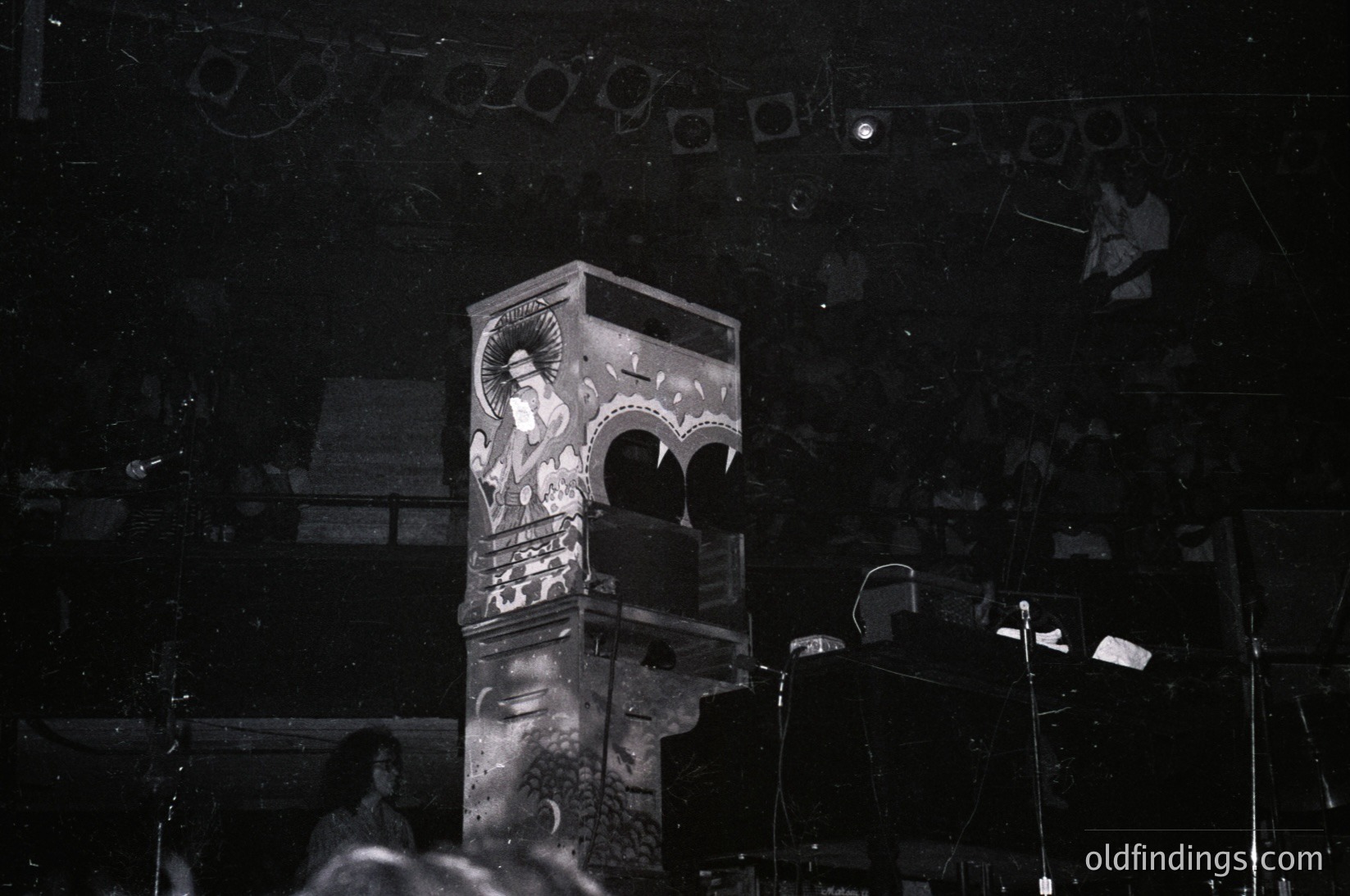 Vintage neon sign featuring a stylized woman in a flowing dress, illuminated against a dark night backdrop. Art deco-inspired design with geometric patterns. Likely 1930s–1950s American diner or bar signage.