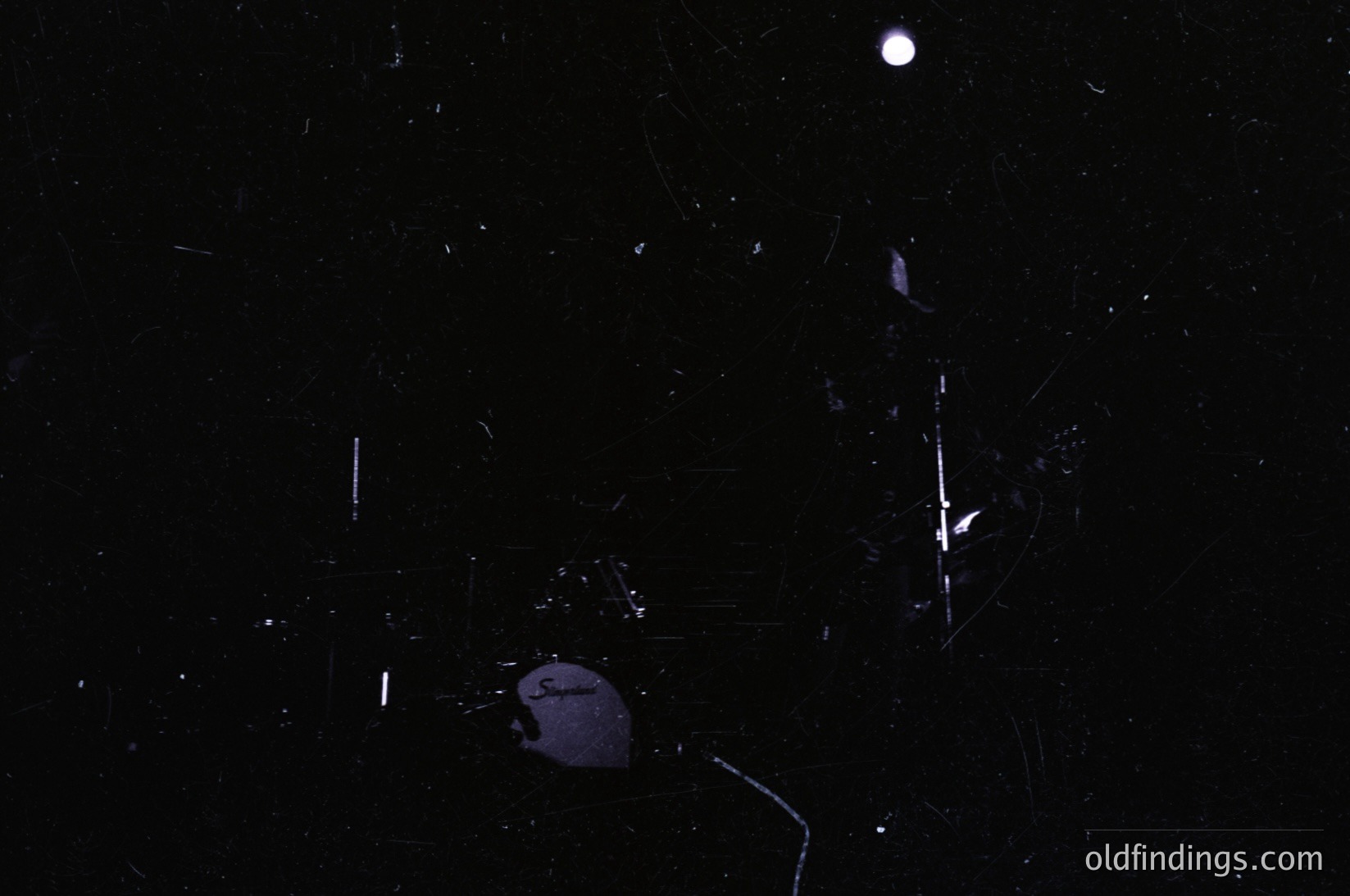 High-contrast nighttime shot of shattered glass fragments under moonlight. Visible cracks and debris suggest a broken surface, likely from a window or mirror. Minimal context prevents precise location/time, but composition evokes themes of fragility and resilience. Ideal for moody, atmospheric stock imagery or conceptual design references.