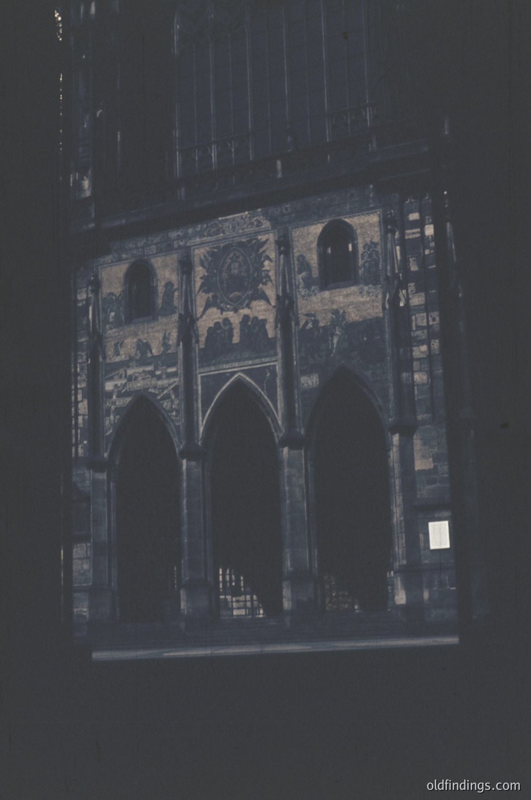 Gothic-style stained glass window featuring three pointed arches with intricate floral and geometric patterns. Likely from a European cathedral or church, mid-20th century. Richly detailed craftsmanship with muted color palette.