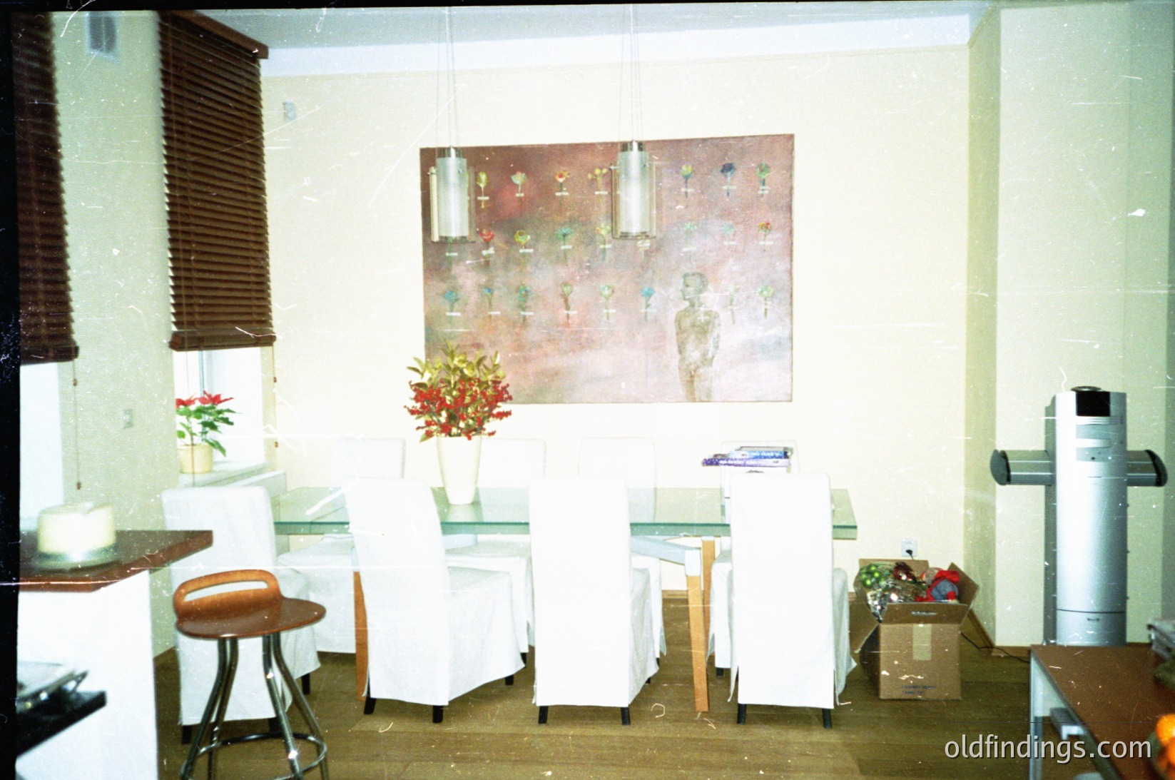 Mid-century modern café interior with minimalist design. White vinyl chairs, a small bar counter, and a vintage wall mural depicting stylized figures. Decorative potted plants and a vintage coffee machine on the right. Soft lighting and neutral tones evoke a 1960s–1970s aesthetic. éDecor