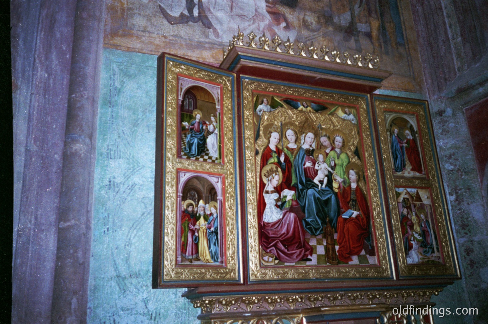 Vibrant 19th-century religious iconostasis featuring Byzantine-style frescoes. Central panel depicts Christ enthroned with apostles; flanking panels show saints and biblical scenes. Gold leaf and intricate detailing highlight sacred figures. Likely Eastern Orthodox, possibly Bulgarian or Romanian. Ideal for historical art research or religious iconography studies.