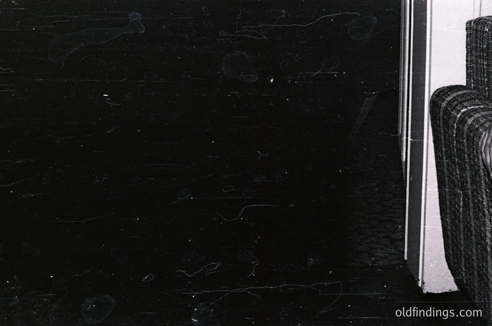 Close-up of a black marble slab with visible veining and a polished edge, likely used in architecture or interior design. The texture and reflective surface suggest high-end materials, possibly from the 20th century. Ideal for stock photography on , , , , .