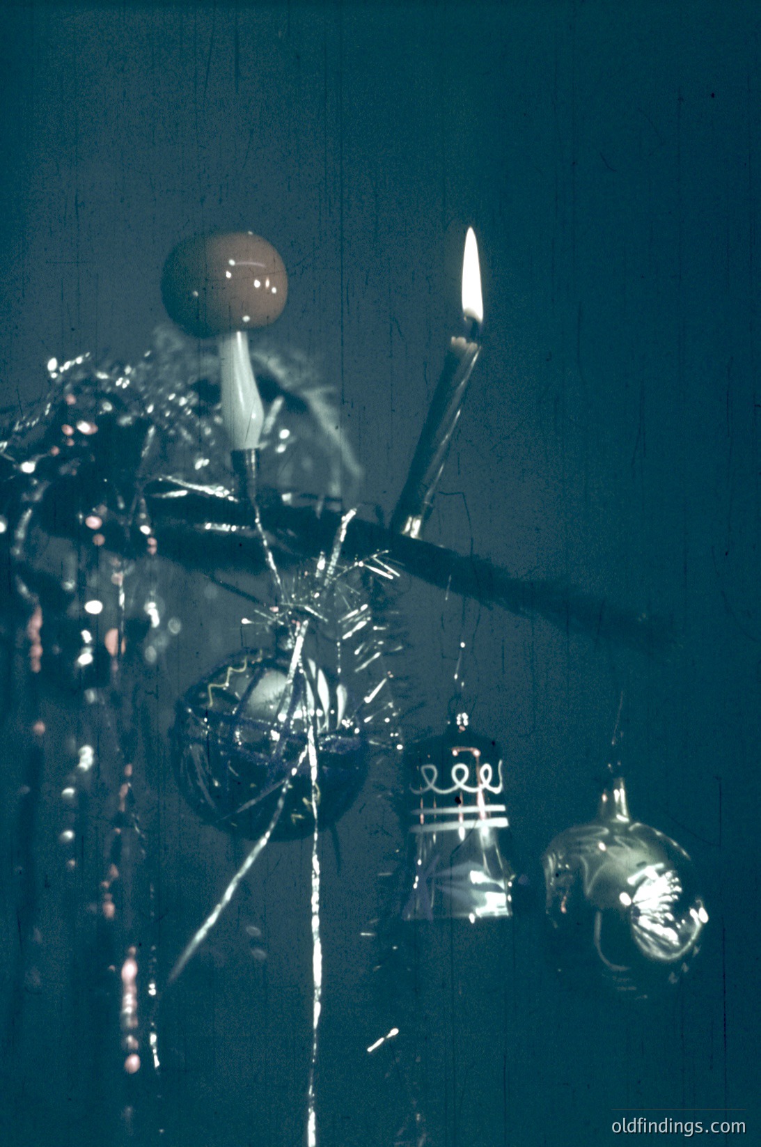 Vintage metallic chandelier with ornate, industrial-style design—fluted globes, candle-like bulbs, and exposed wiring. Likely from mid-20th century (1950s–1960s) for mid-century modern or industrial decor. Reflective surfaces capture ambient light, enhancing its retro aesthetic.