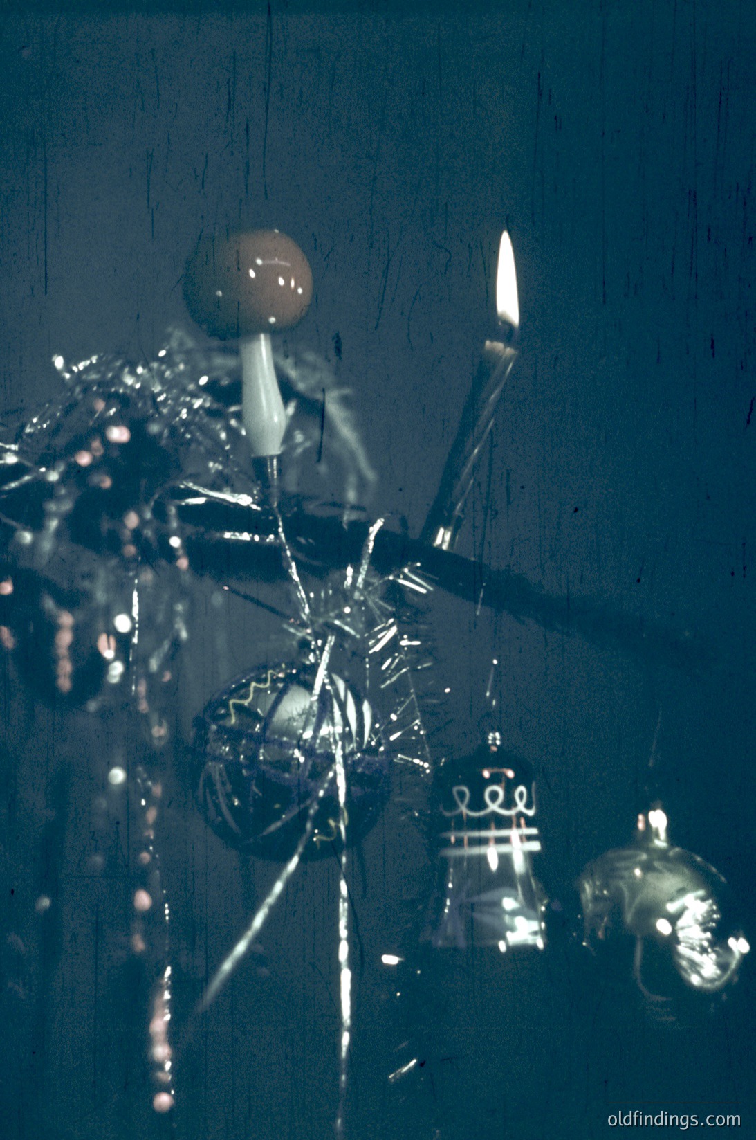 Vintage glass chandelier with intricate Art Nouveau-style metalwork, featuring ornate floral and geometric motifs. Warm candlelight illuminates the crystals, casting soft reflections. Likely from early 20th-century European interior design, possibly .