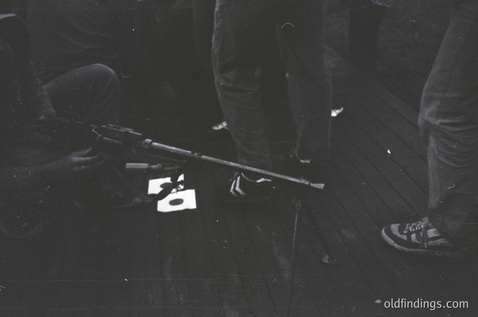 Black-and-white close-up of a vintage 8-track tape player on a reflective surface, with a cassette labeled "50" placed on the tape deck. The design reflects mid-20th-century audio technology, likely or . Useful for retro tech, nostalgia, or historical research on analog audio.