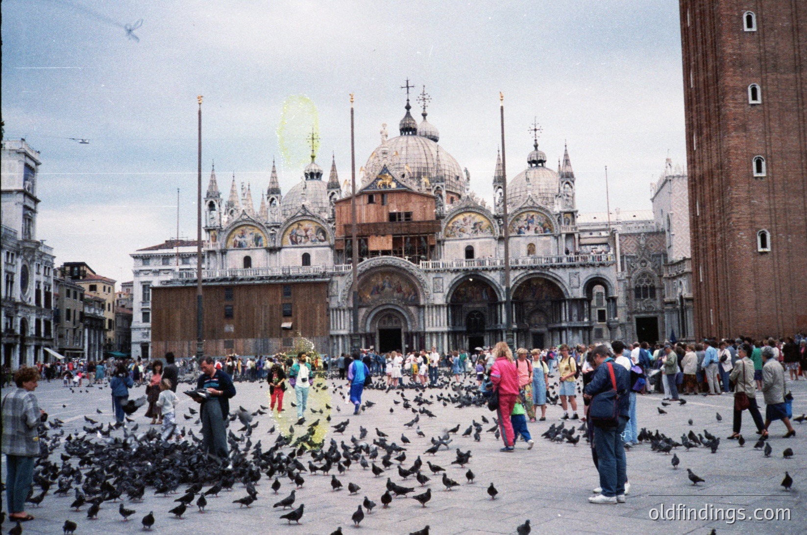 Venice’s St. Mark’s Basilica () dominates this bustling Piazza San Marco (), with its Byzantine domes and intricate mosaics. Flocks of pigeons () fill the square, while tourists explore the historic site. The adjacent Campanile () and Doge’s Palace () frame the scene. Likely captured in the late 20th century, this image captures Venice’s iconic blend of architecture and urban life.