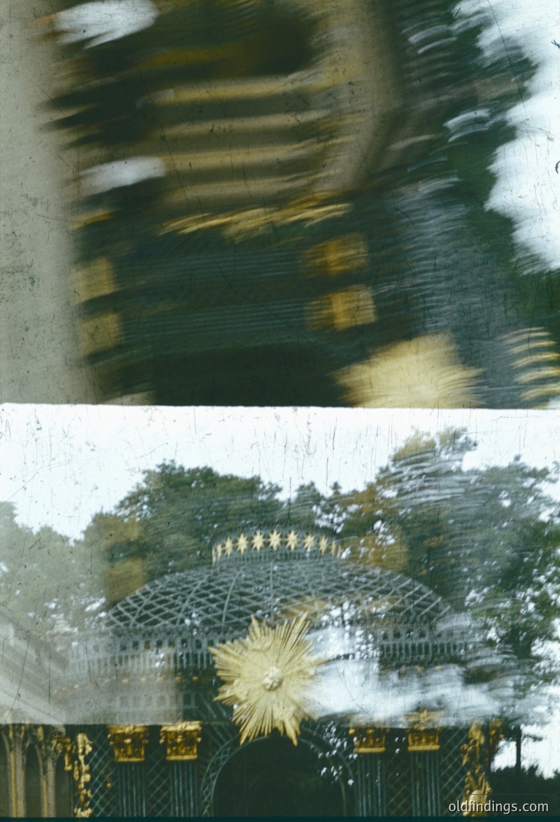 Blurred motion shot of a **1970s-era Ferris wheel** with vintage brass detailing, likely at an amusement park. Snowflakes and raindrops create dynamic streaks, emphasizing winter weather. Architectural elements suggest mid-century design with geometric metal framing.