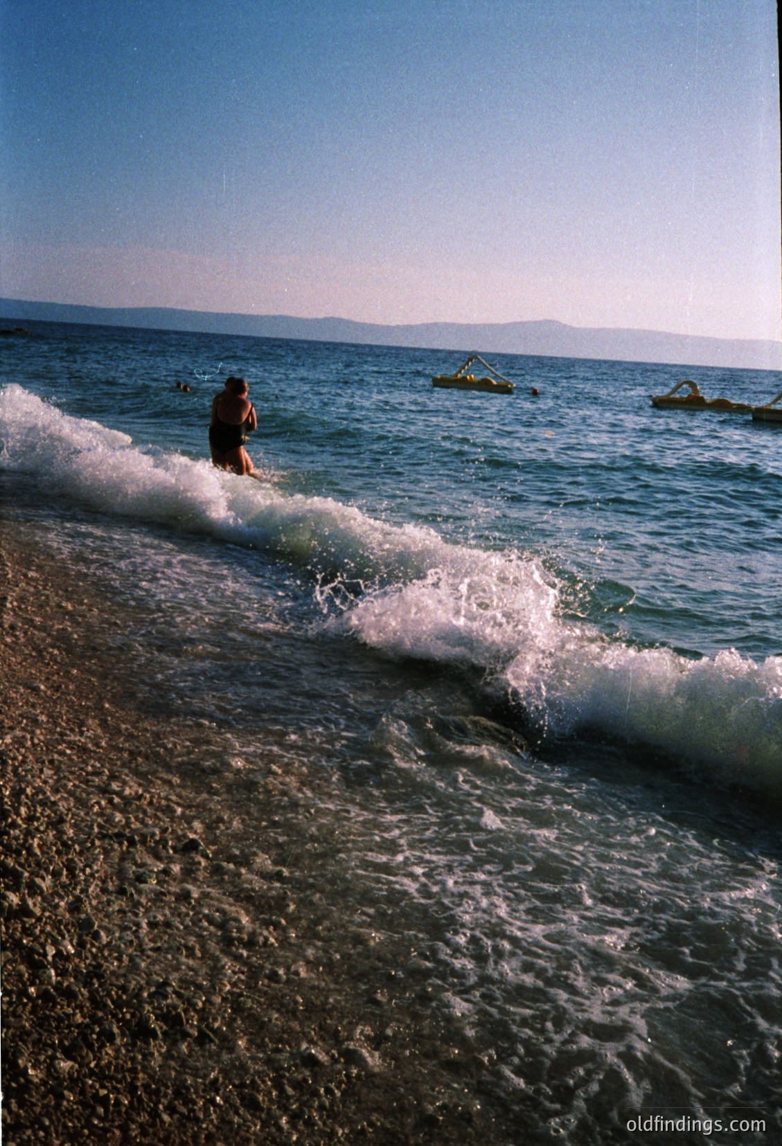 Surfer riding a powerful wave in mid-air, framed by turbulent ocean foam. Dynamic composition captures motion and raw energy. Likely coastal California or Hawaii, mid-20th century surf culture. Ideal for action sports, travel, or surfboard design references.