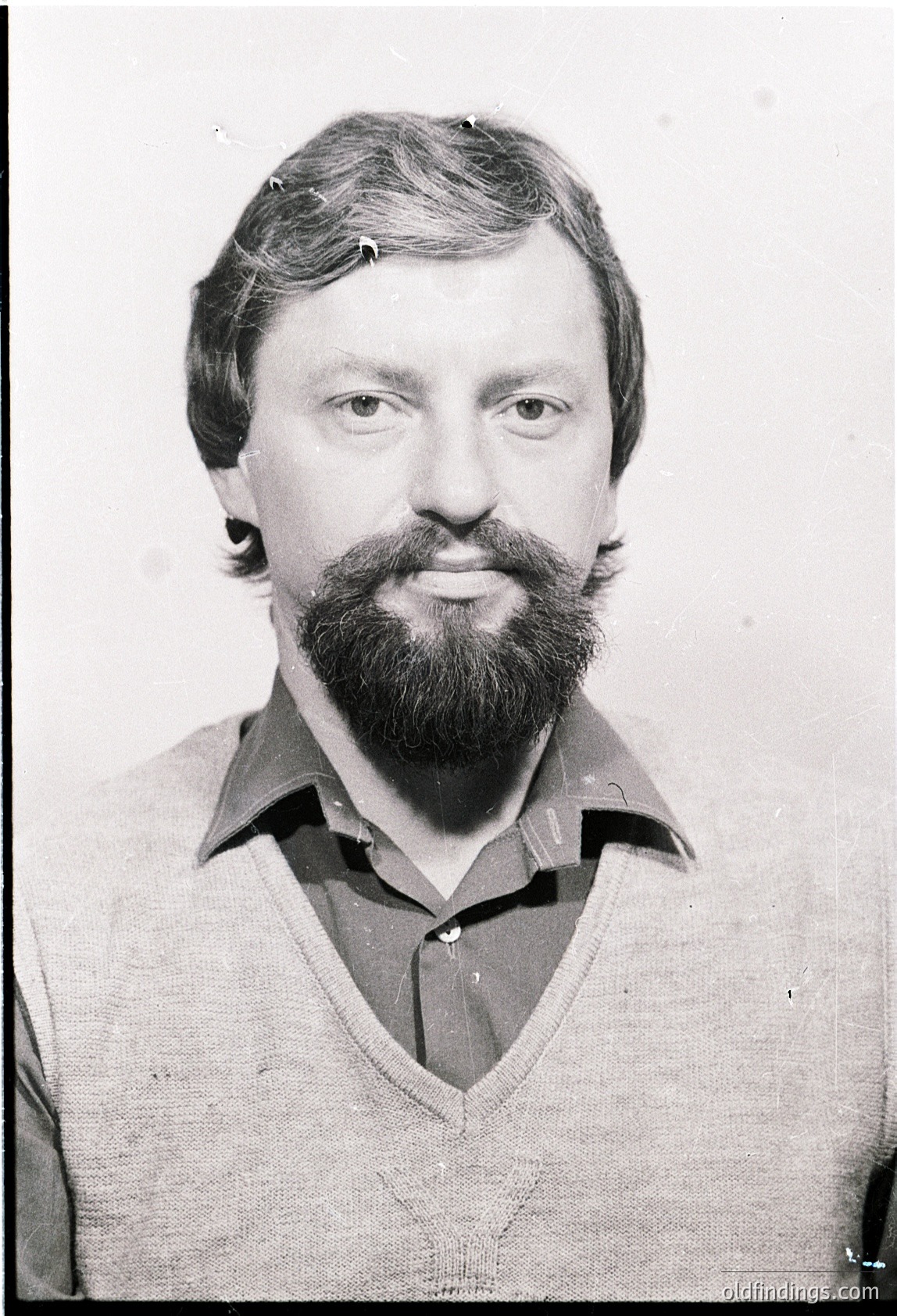 Portrait of a man with a full beard and mustache, wearing a collared sweater. Mid-20th century styling suggests or . Plain background indicates possible identification or professional photo.
