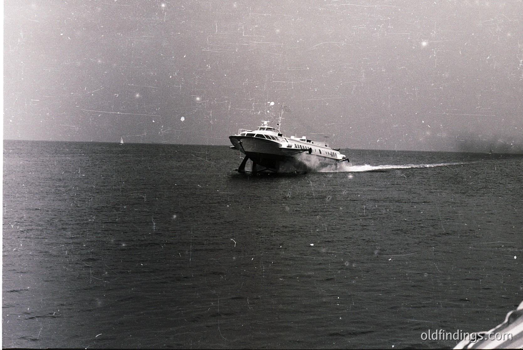 Vintage black-and-white photo of a high-speed passenger ferry cutting through choppy waters, likely mid-20th century. Sleek hull and wake suggest coastal or short-sea travel.