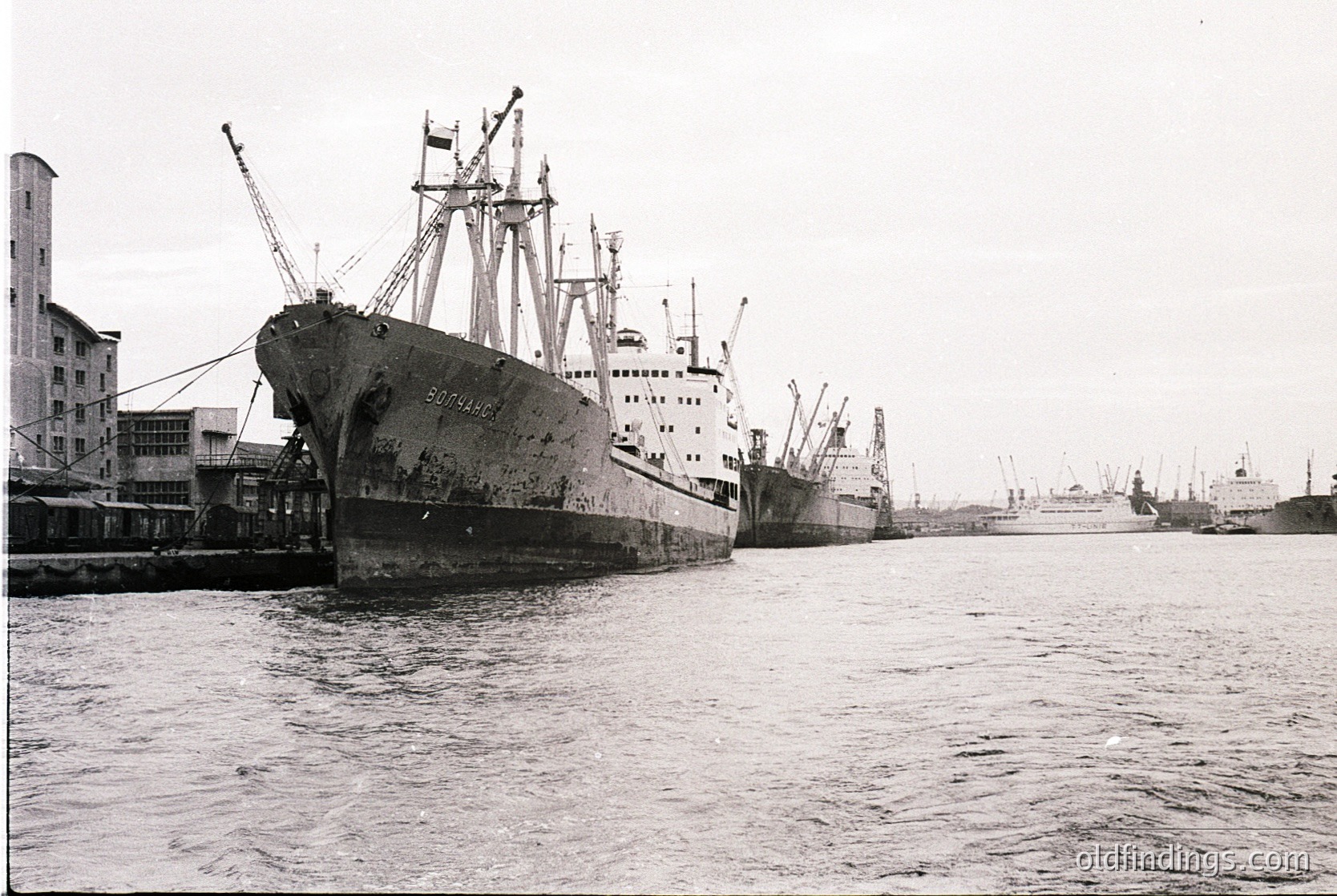 Where is this: mid-20th century industrial port scene featuring a rusted cargo ship ("Sofia")