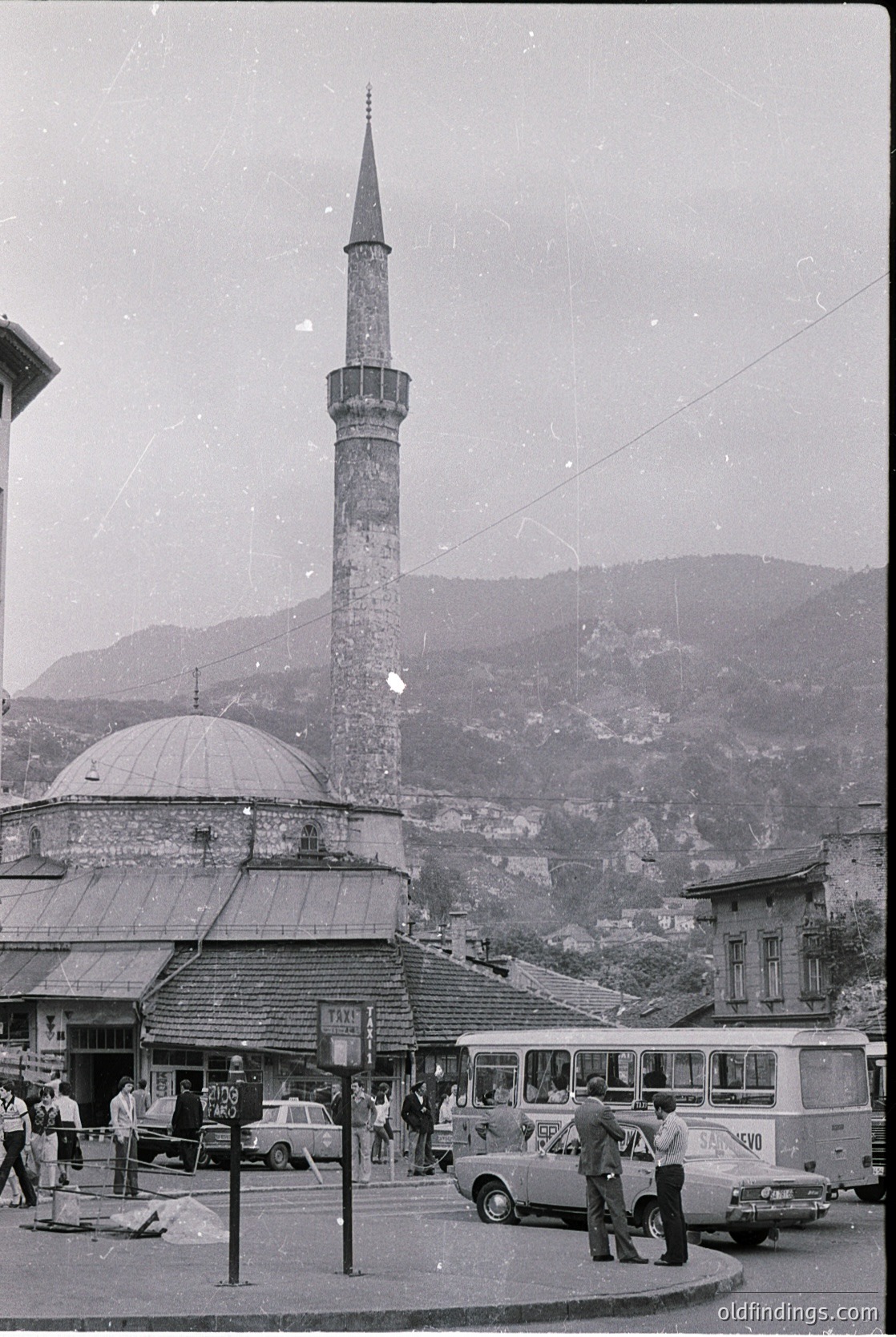 Case 17: mid-20th century street scene featuring a prominent Ottoman-style minaret and domed mosque