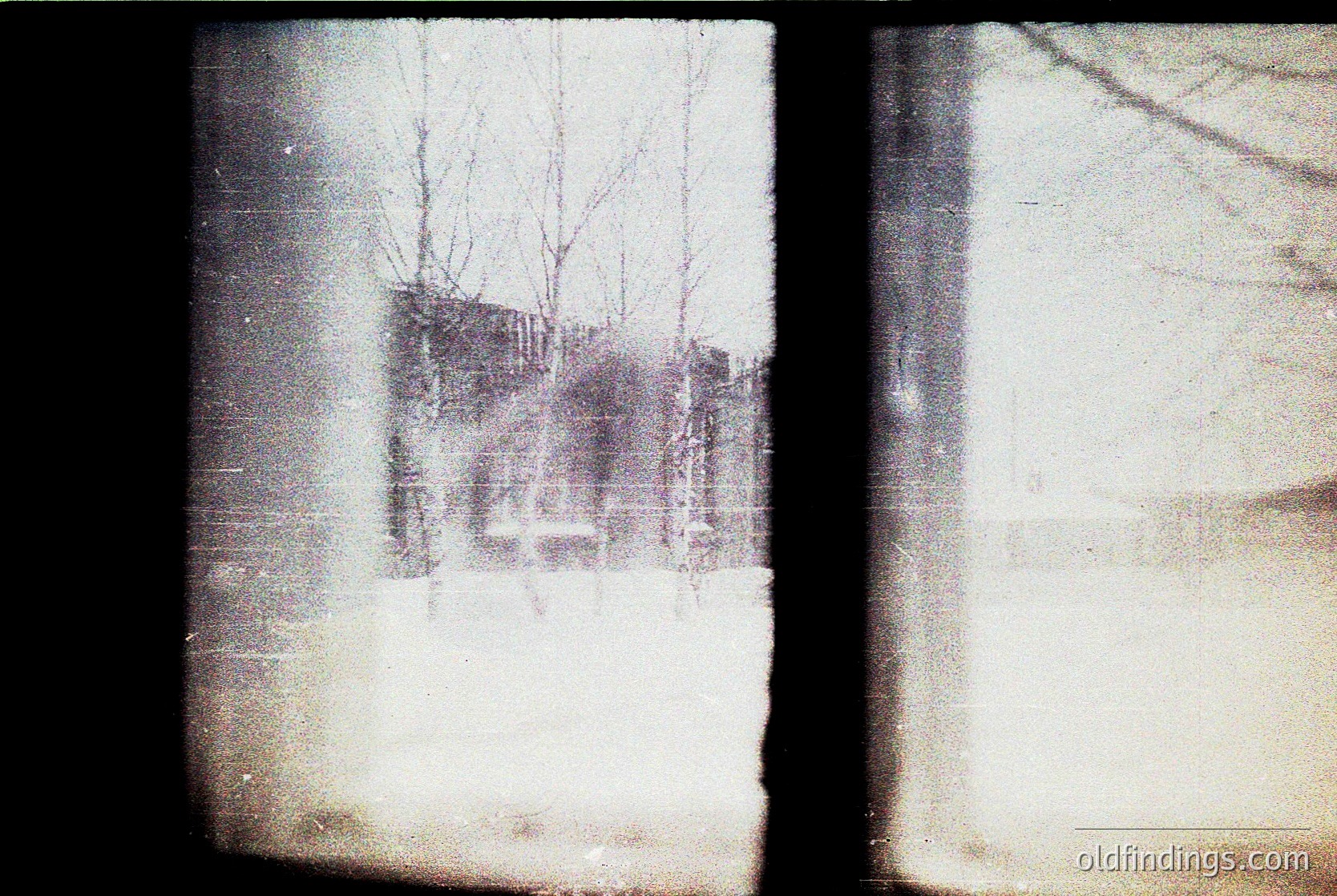 Vintage sepia-toned photo of a foggy, snow-covered urban scene. Bare trees frame a partially obscured multi-story building with visible balconies and windows. Likely 20th-century European architecture.