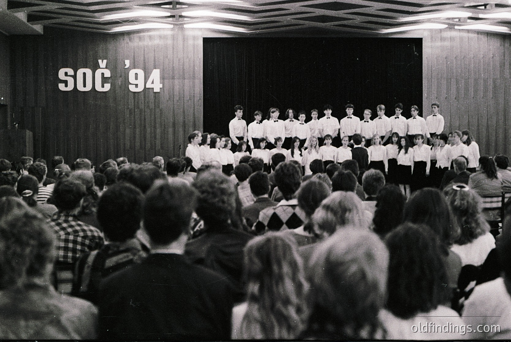 Young choir performing on stage at **SOC '94** event, likely a youth festival in Czechoslovakia (now Czech Republic/Slovakia). Black-and-white photo captures uniformed singers in front of attentive audience, mid-1990s. Stage backdrop features bold "SOC '94" signage. Ideal for historical research, cultural archives, or educational content.