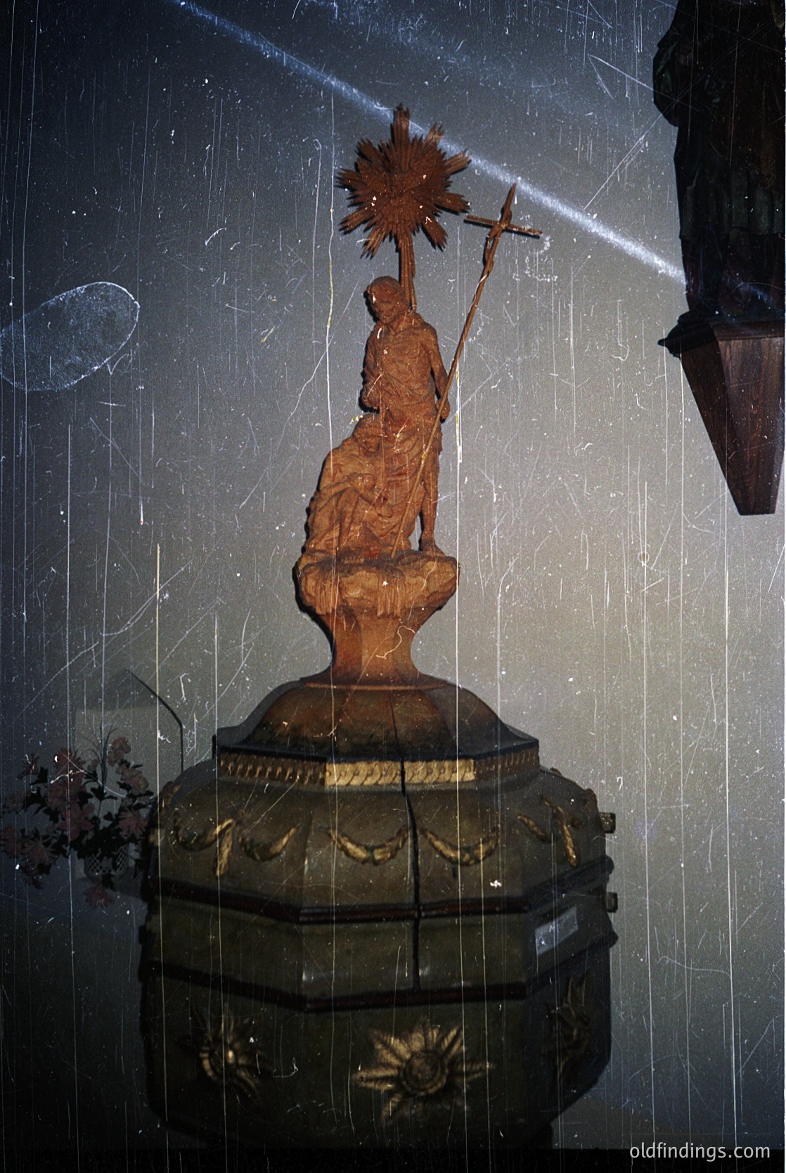 Religious wooden statue of a robed figure holding a sunburst halo and cross, mounted on an ornate gilded pedestal. Likely a 19th-century Eastern Orthodox icon, possibly Bulgarian.