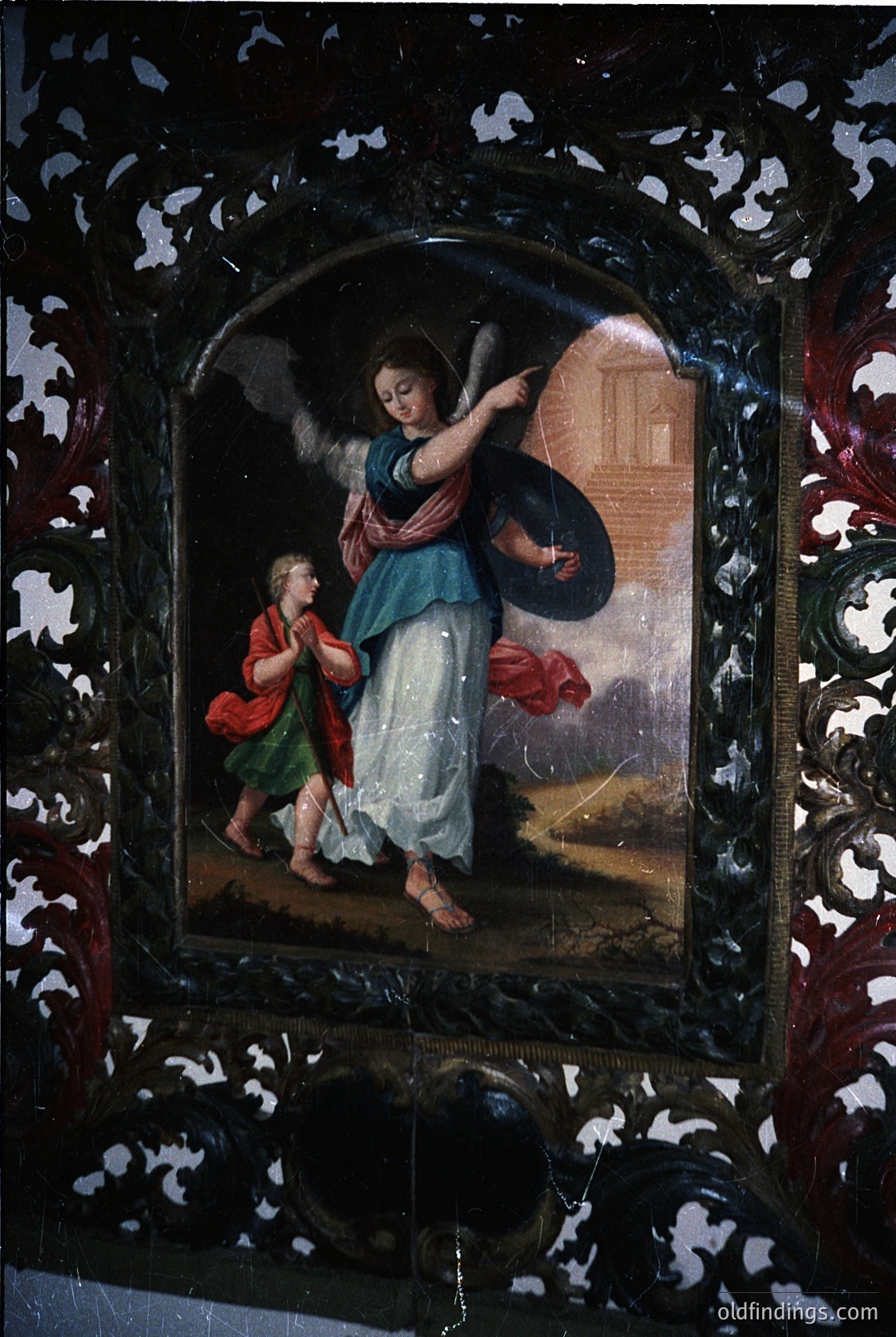 Religious icon depicting an angel (left) and a child (right) in Baroque-style attire, framed in ornate gilded metalwork. The angel holds a scroll, while the child grasps a staff. Likely Eastern Orthodox, 18th–19th century.