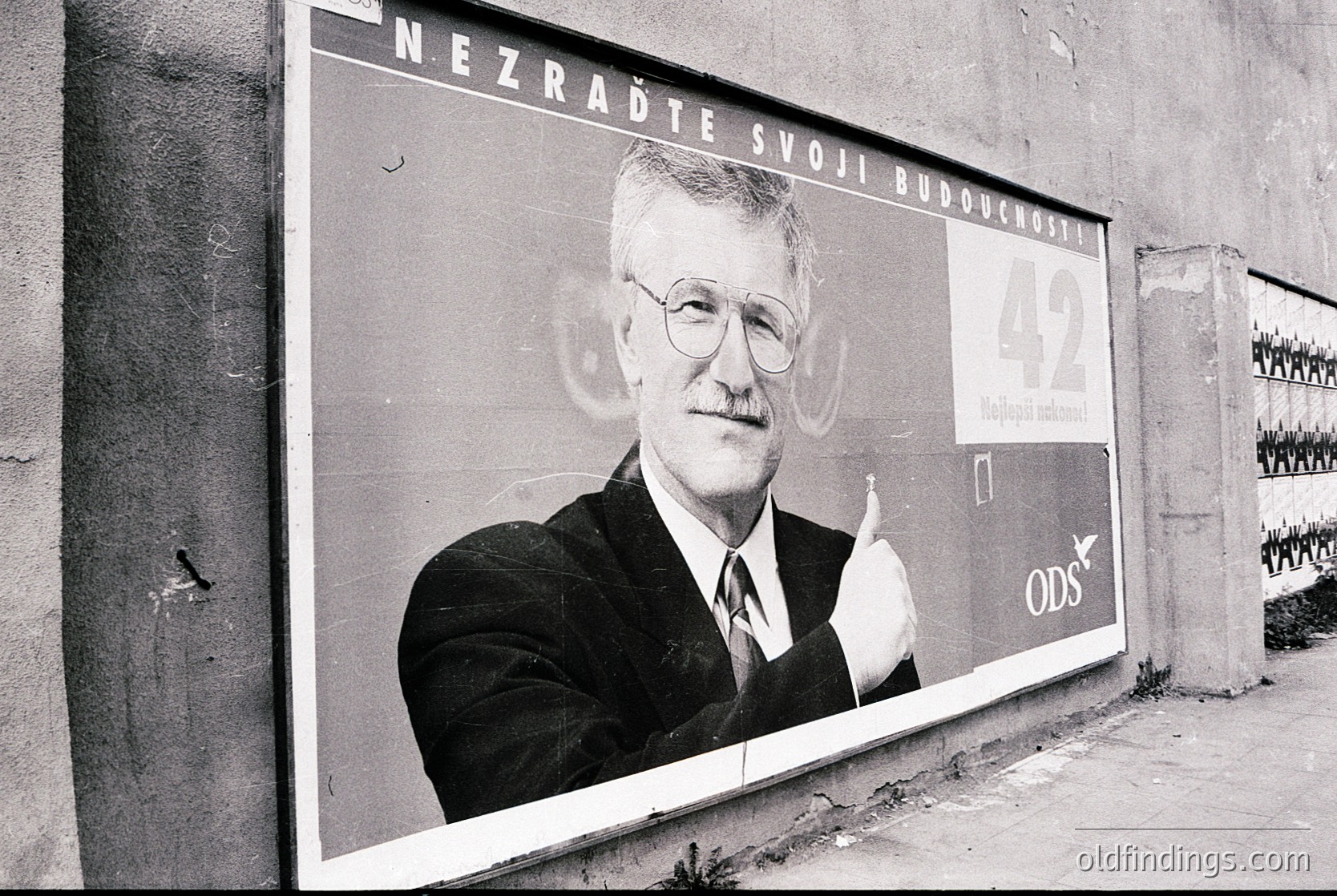 Vintage political campaign poster featuring a man in a suit with text in Czech: *"Nezradte svoji budoucnost"* ("Betray not your future"). Candidate for ODS (Civic Democratic Party), likely from the 1990s Czech Republic. Urban setting with worn concrete wall and graffiti. Valuable for historical political research and design references.