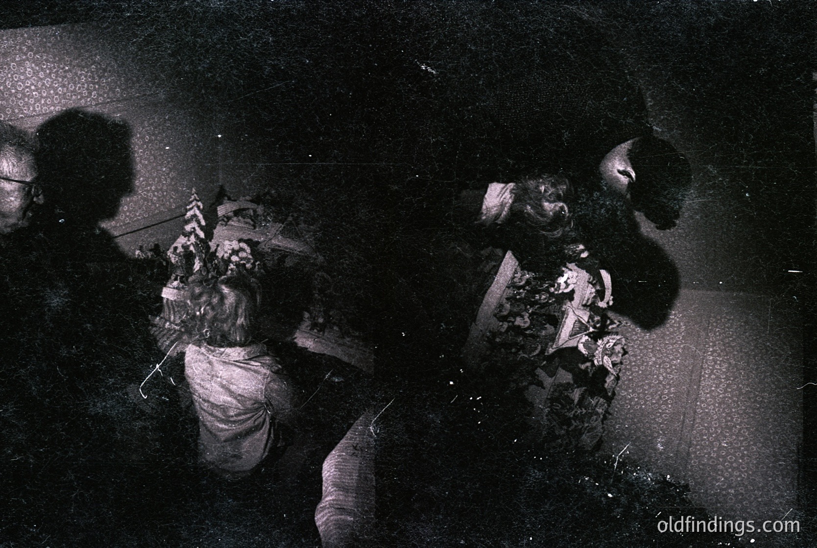 Vintage black-and-white photo of two women engaged in a dance or ritual, likely from the 1960s–1970s. One woman wears a patterned headscarf and layered clothing, the other a simple blouse. Dynamic movement and blurred lighting suggest spontaneity. Potential cultural or folk-dance context.