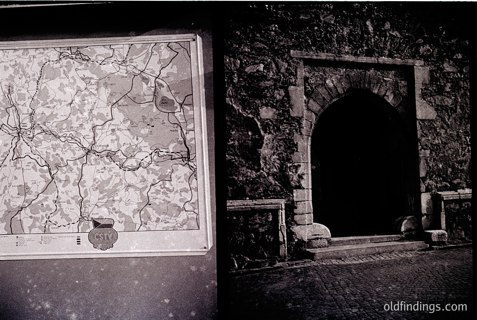 Black-and-white archival photo of a framed vintage map (1960s-70s) depicting a region with detailed road networks, overlaid on a stone archway entrance. The map’s border features a crest with "CS" insignia, suggesting Eastern European origin. The archway’s weathered stone and cobblestone floor suggest historical or preserved architecture.