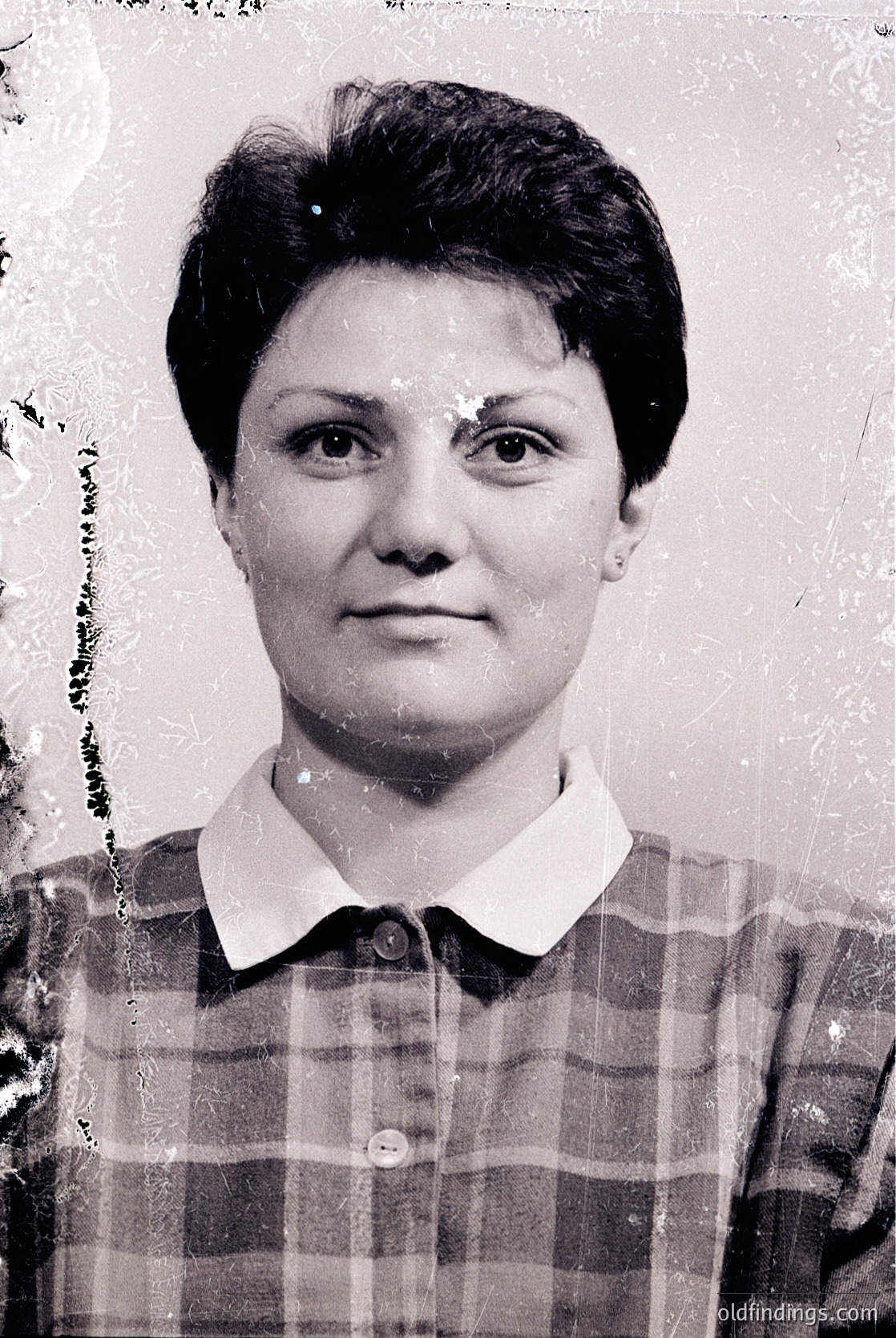 Portrait of a woman in a vintage , likely from the –. Her short, textured hairstyle and direct gaze suggest a formal or identification-style photograph. The sepia tone and slight wear indicate archival quality.