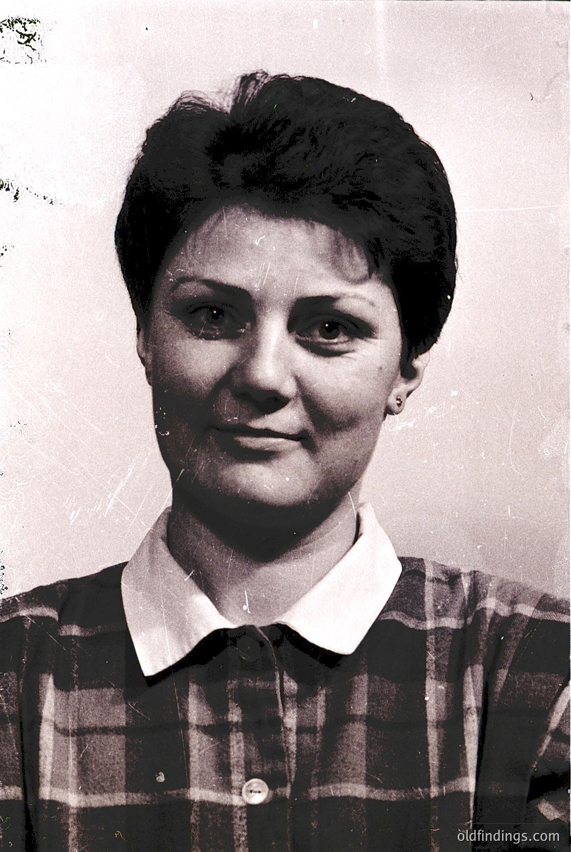 Vintage black-and-white portrait of a woman in a plaid blouse, short hairstyle, and earrings. Likely a mid-20th-century ID or school photo ( ) --- *Note: The exact location/time is speculative due to lack of context, but stylistic cues suggest Eastern European mid-20th century.*