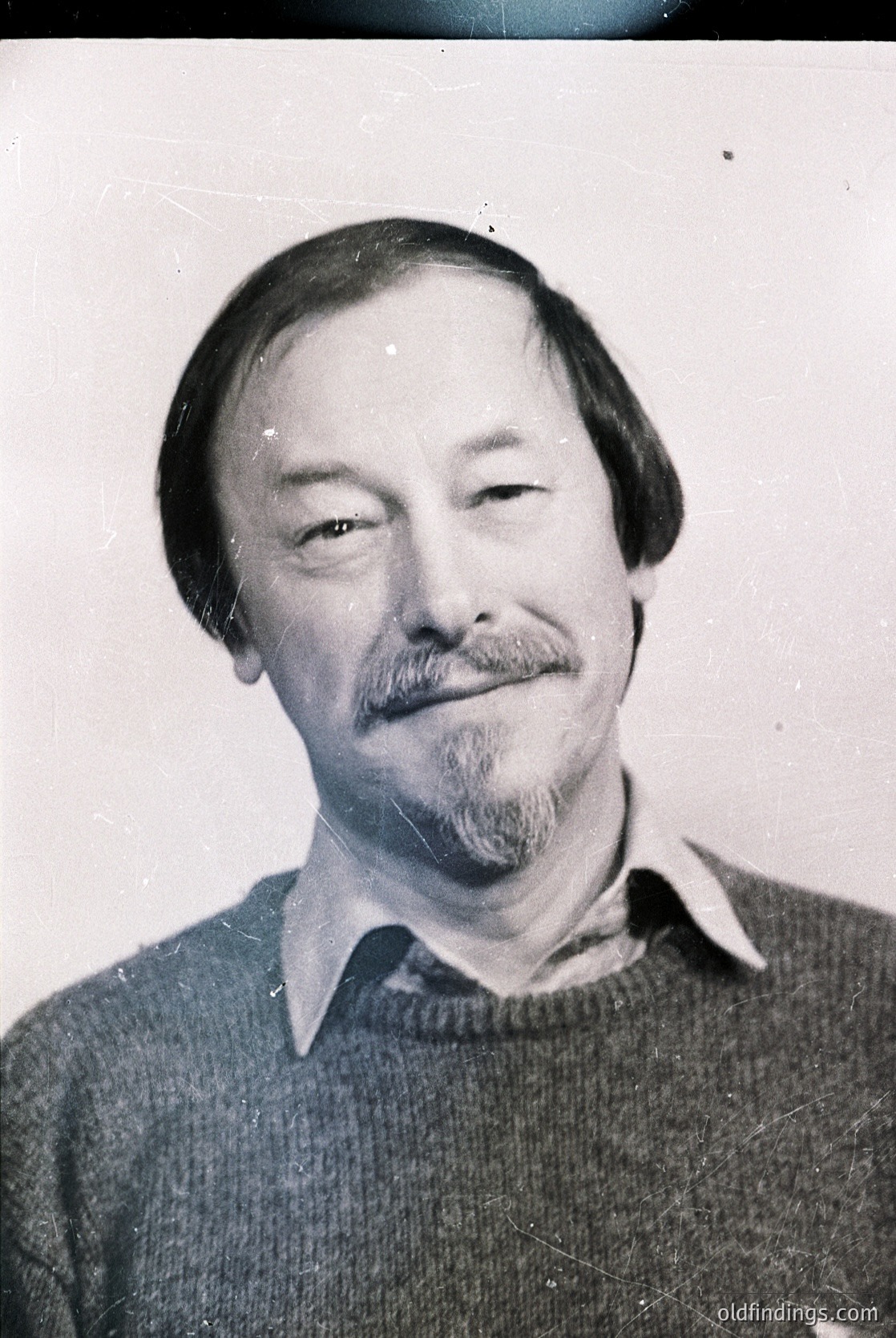 Portrait of a man with a mustache and short hair, wearing a collared sweater. Black-and-white, mid-20th century style. Likely professional or identification photo.