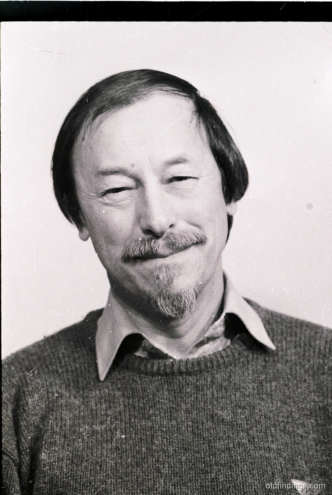 Portrait of a man with a mustache and beard, wearing a collared sweater. Classic mid-20th century style, likely or . Neutral expression with closed eyes, evoking contemplation or candidness.