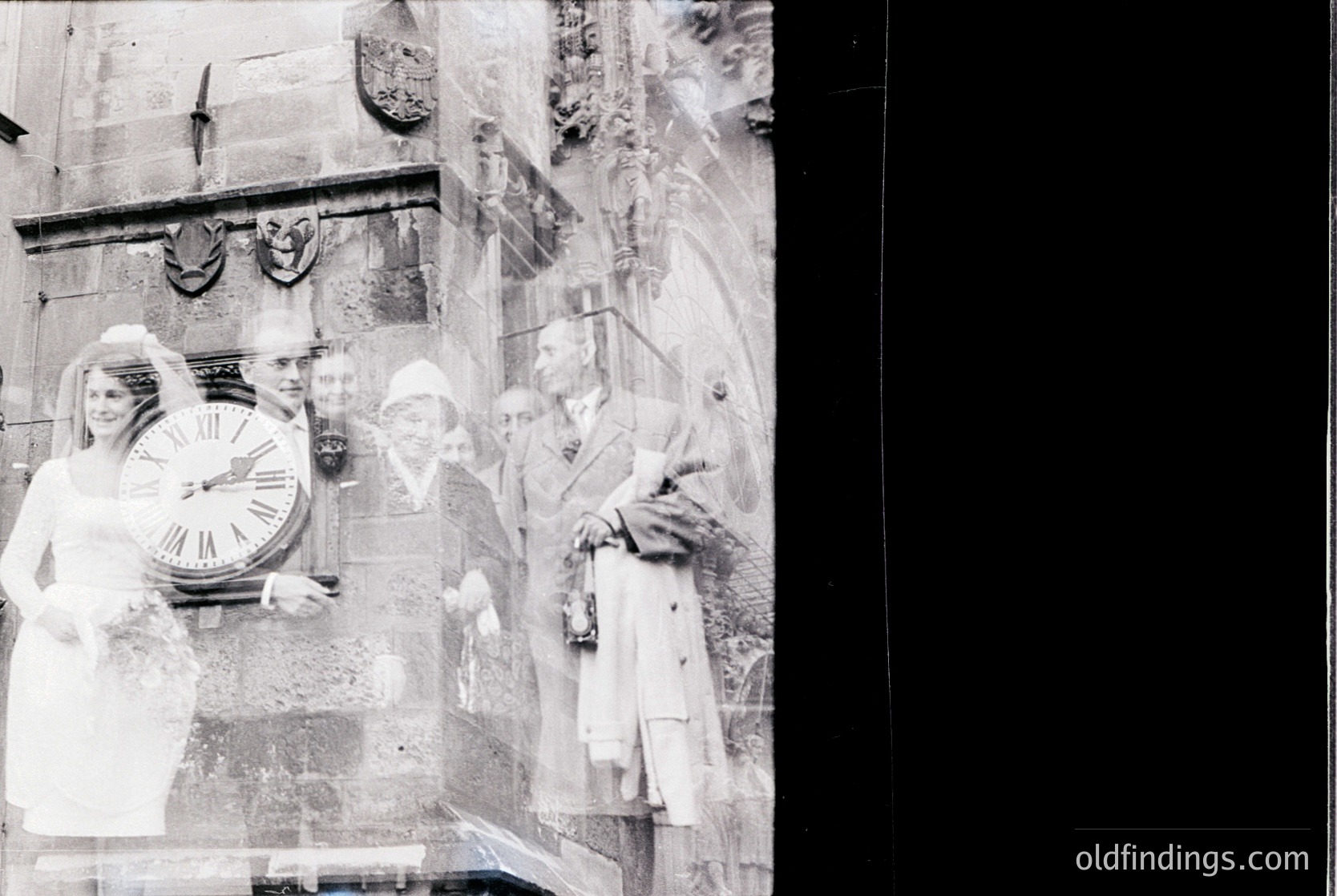 Relief sculpture depicting three figures in classical attire beside a large clock face, likely from 19th-century European architecture. Figures appear to represent time, labor, and industry.