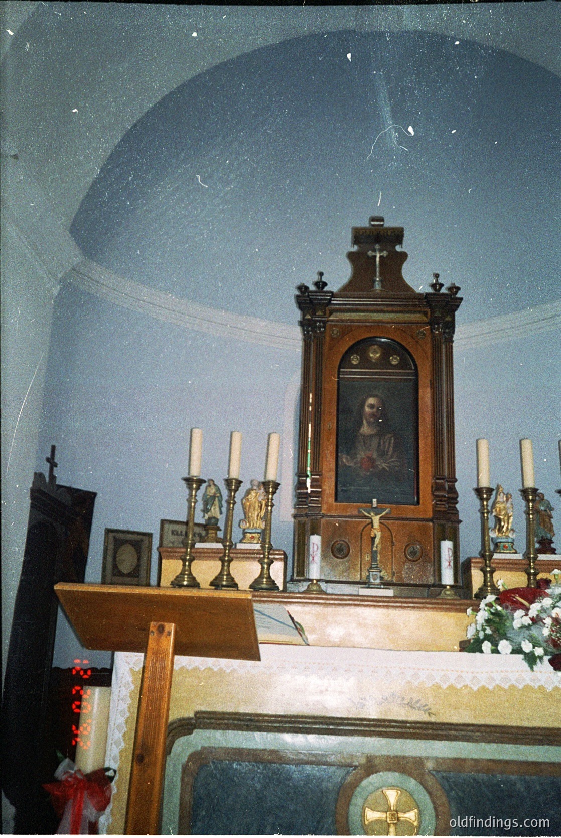 Ornate wooden iconostasis in a domed Orthodox church interior, featuring a central religious portrait framed by candle holders and a crucifix. Intricate carvings and gold accents highlight the altar’s sacred significance. --- *Note: Exact time period/location indeterminate but stylistic cues suggest 19th-century Balkan Orthodox tradition.*