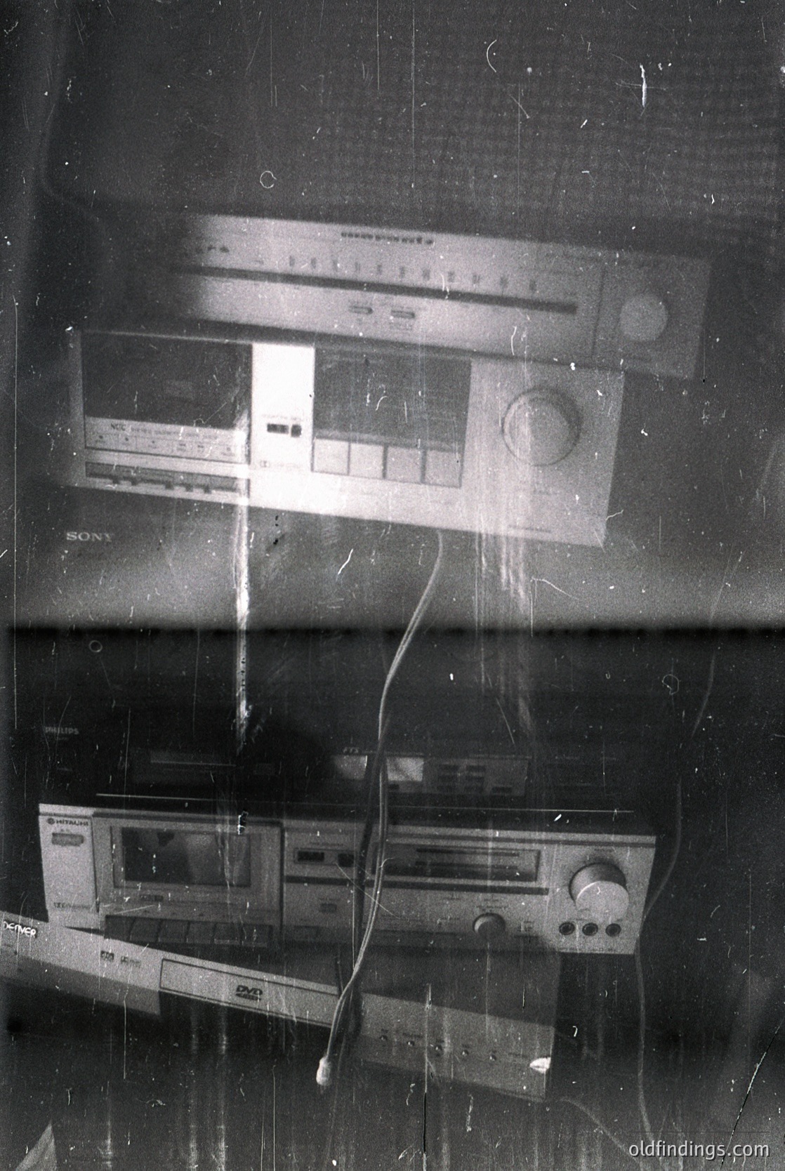 Vintage stereo equipment: Sony cassette deck (bottom) and Portorock tape recorder (top) on a scratched wooden surface, likely a 1970s–1980s home setup. Portorock’s retro design and Sony’s iconic branding reflect mid-century audio tech. Ideal for retro tech collections, design references, or historical research.