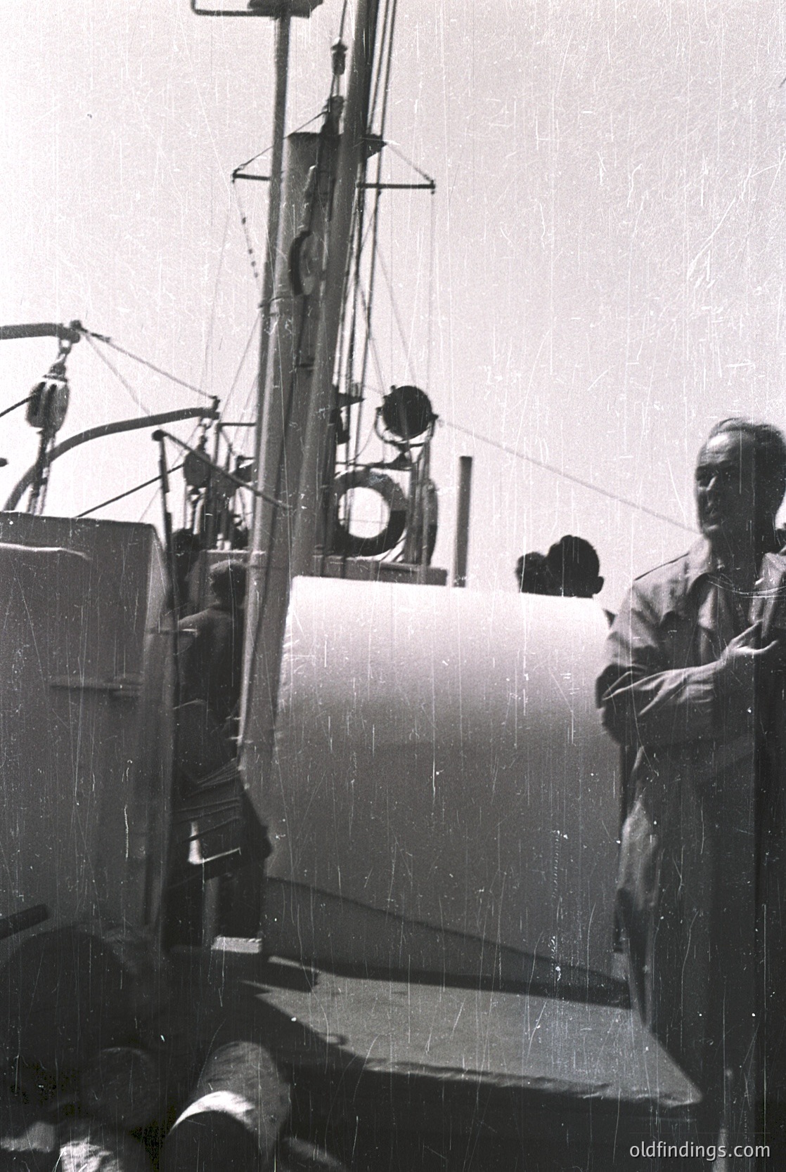 Mid-20th century fishing vessel with vintage navigation equipment: round porthole, lantern, and rigging. Man in dark suit stands on deck, hands on hips. Likely Eastern Bloc maritime industry, 1950s–1970s.