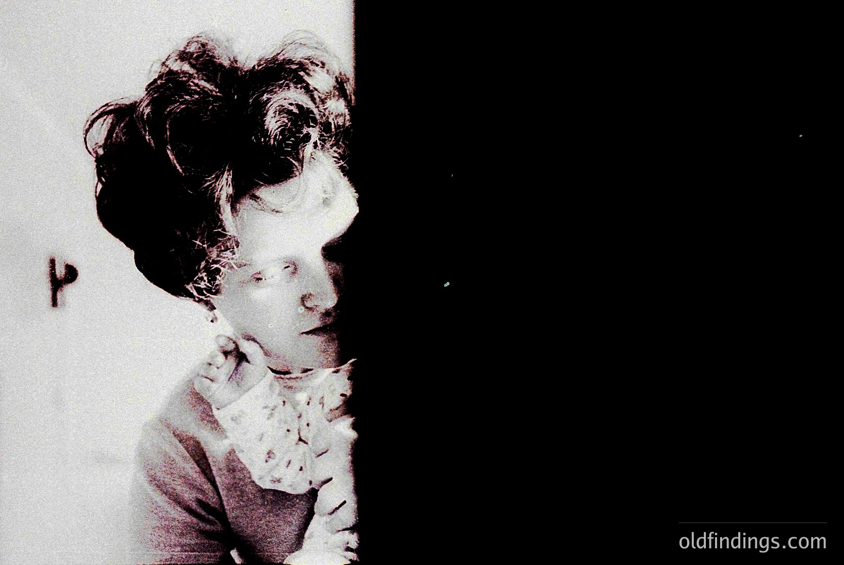 Vintage sepia-toned portrait of a woman with voluminous 1920s-style curls, clutching a lace-trimmed handkerchief. Dramatic lighting creates high-contrast shadows. Likely early 20th-century fashion photography.