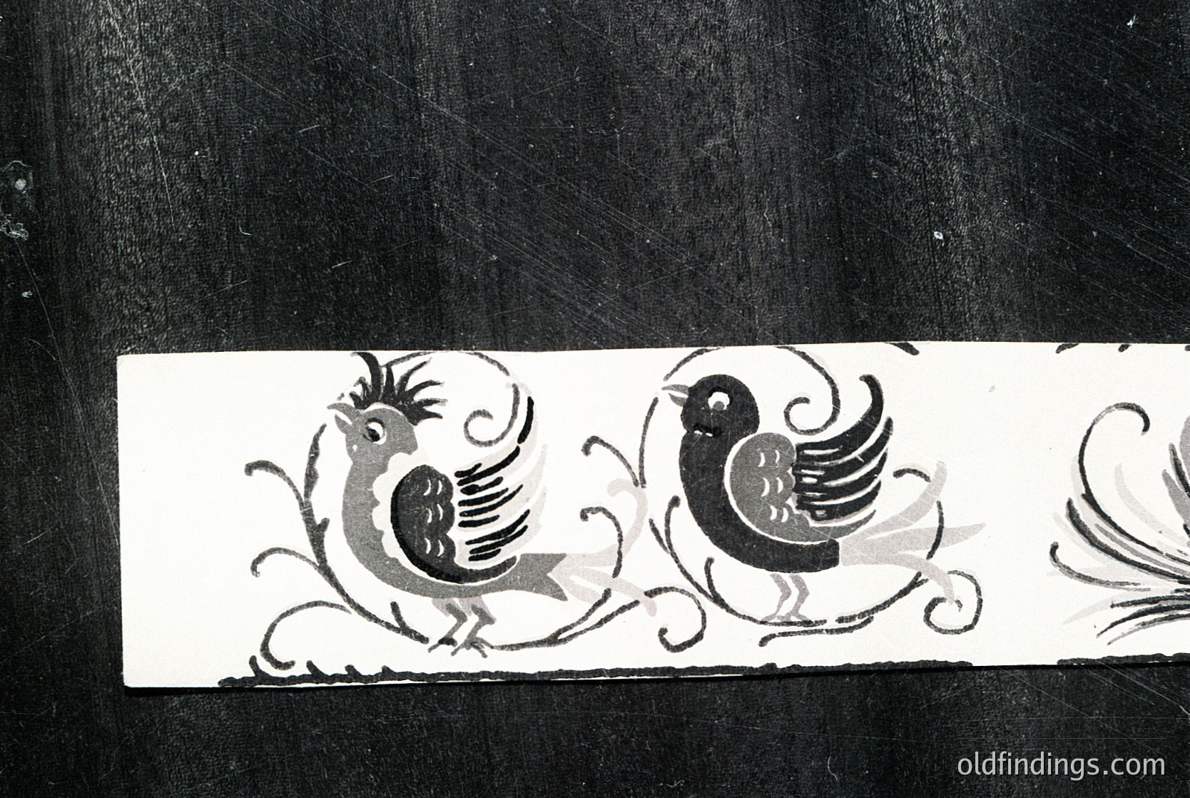 Decorative relief featuring stylized roosters with ornate scrollwork, likely from a 19th-century European textile or furniture detail. Symmetrical motifs suggest craftsmanship tied to Victorian or Art Nouveau influences.