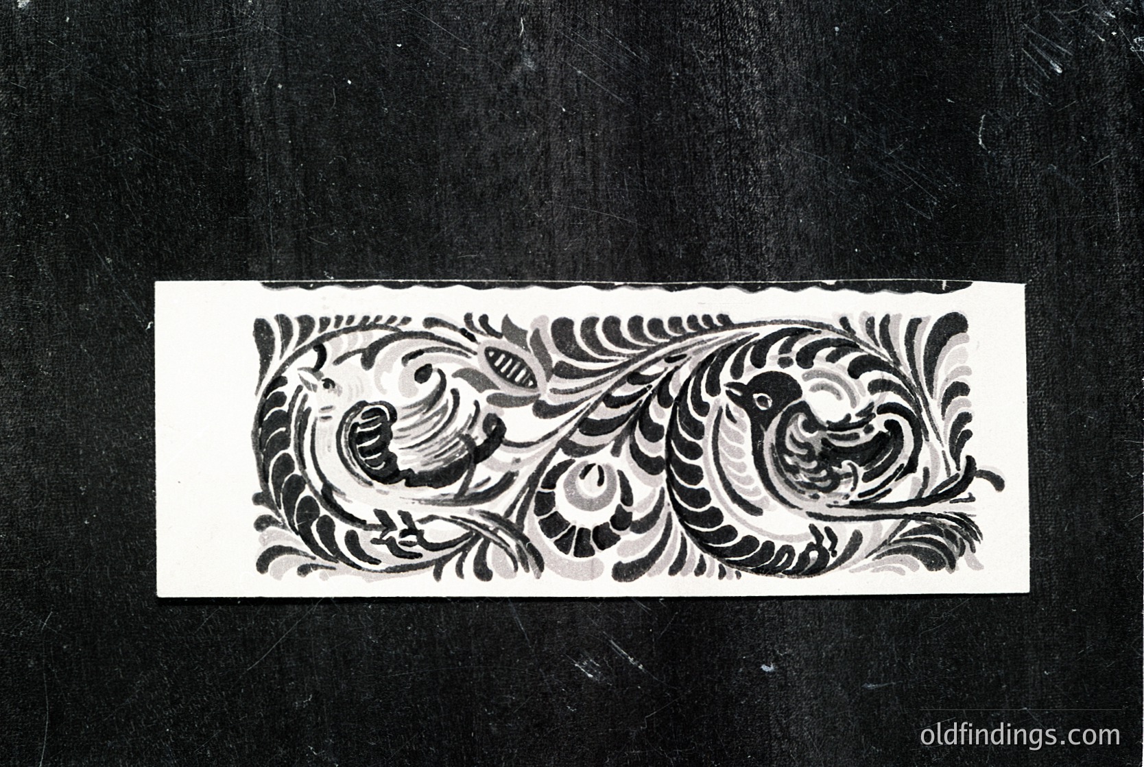 Vintage monochrome embroidery hoop design featuring symmetrical floral motifs with birds perched on stylized branches. Likely 19th–early 20th century European folk art. Ideal for historical textile research or vintage-inspired design projects.