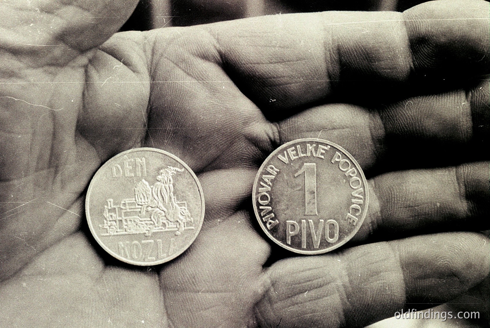 1971 Czechoslovakian 1 *Pivo* (1 Koruna) coin featuring locomotive design on reverse, "DEN" (Den national) on obverse. Black-and-white archival style.