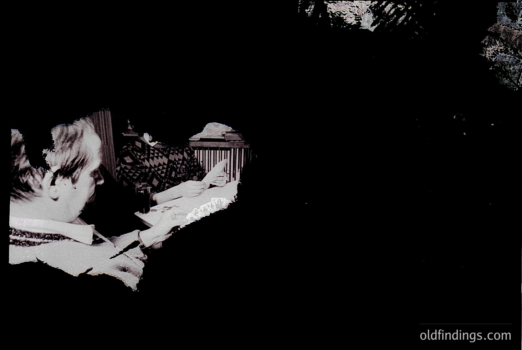 Low-contrast black-and-white photo of a seated figure in a dimly lit, classical-style interior. The person appears to be reading or writing at a desk with ornate columns and a patterned wall. Likely mid-20th century, possibly . Evokes --- *Note: Due to low resolution and contrast, finer details (e.g., exact location, time period) are indeterminable. Tags reflect broad, searchable themes.*