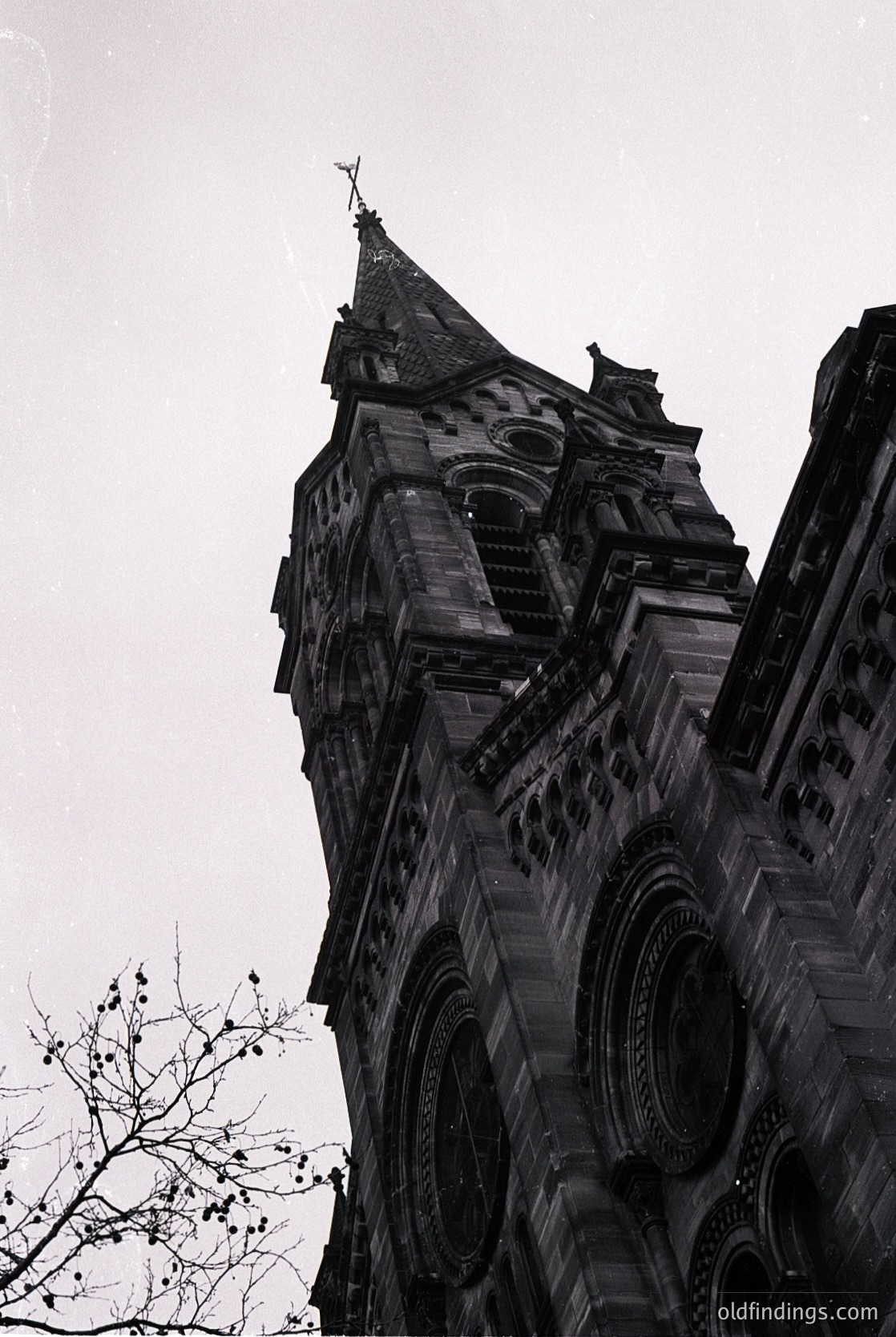 Gothic Revival-style church tower with pointed spire, intricate stone carvings, and arched buttresses. Architectural details include decorative arcading and a cross atop. Likely European, 19th-century construction. Ideal for historical architecture, religious studies, or period design references.