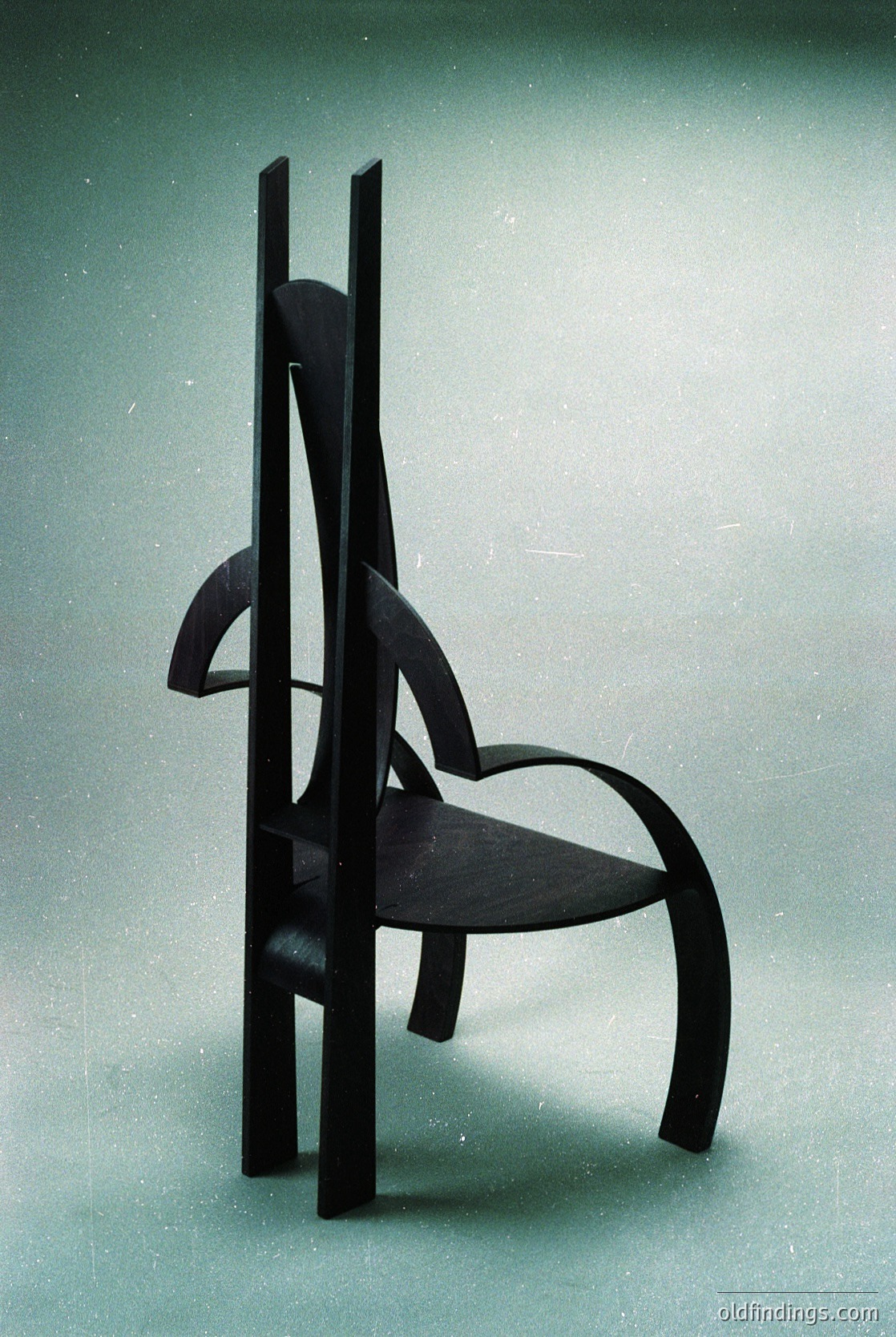 Mid-century modern chair with sculptural wooden frame and curved seat, showcasing organic lines and minimalist design. Likely from the 1950s–1960s, reflecting Scandinavian or Bauhaus influences.