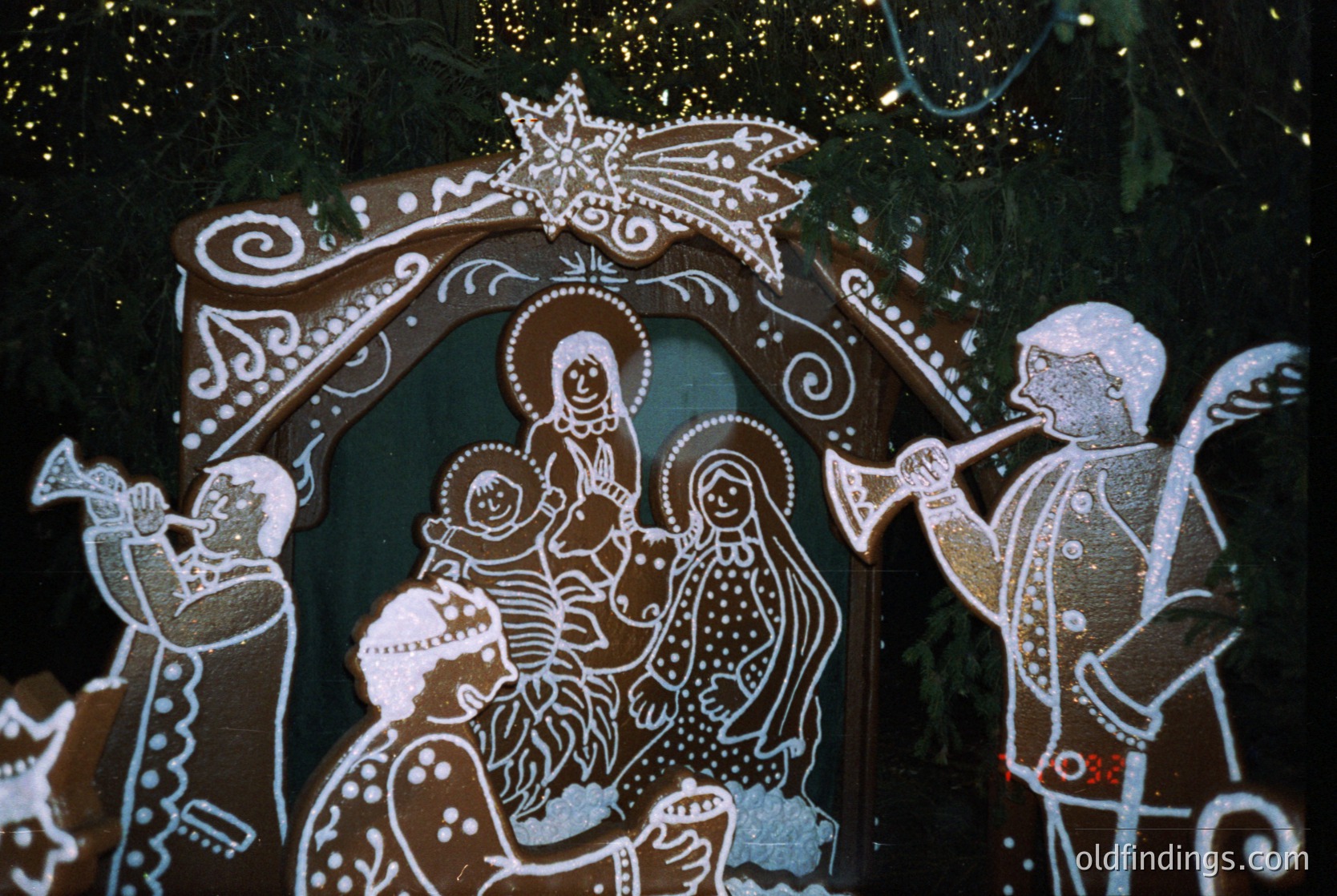 Traditional folk art mural depicting the Nativity scene with stylized figures in white and brown chalk on a dark background. Shepherds, Mary, Joseph, and infant Jesus central, flanked by musicians. Ornate arch and star motif at top. Likely Eastern European folk tradition, possibly or folk art. -1990s rural craftsmanship. --- *Note: Without clearer geographical or contextual clues, tags are generalized to common Eastern European folk art traditions. For precise identification, additional research or metadata would be required.*