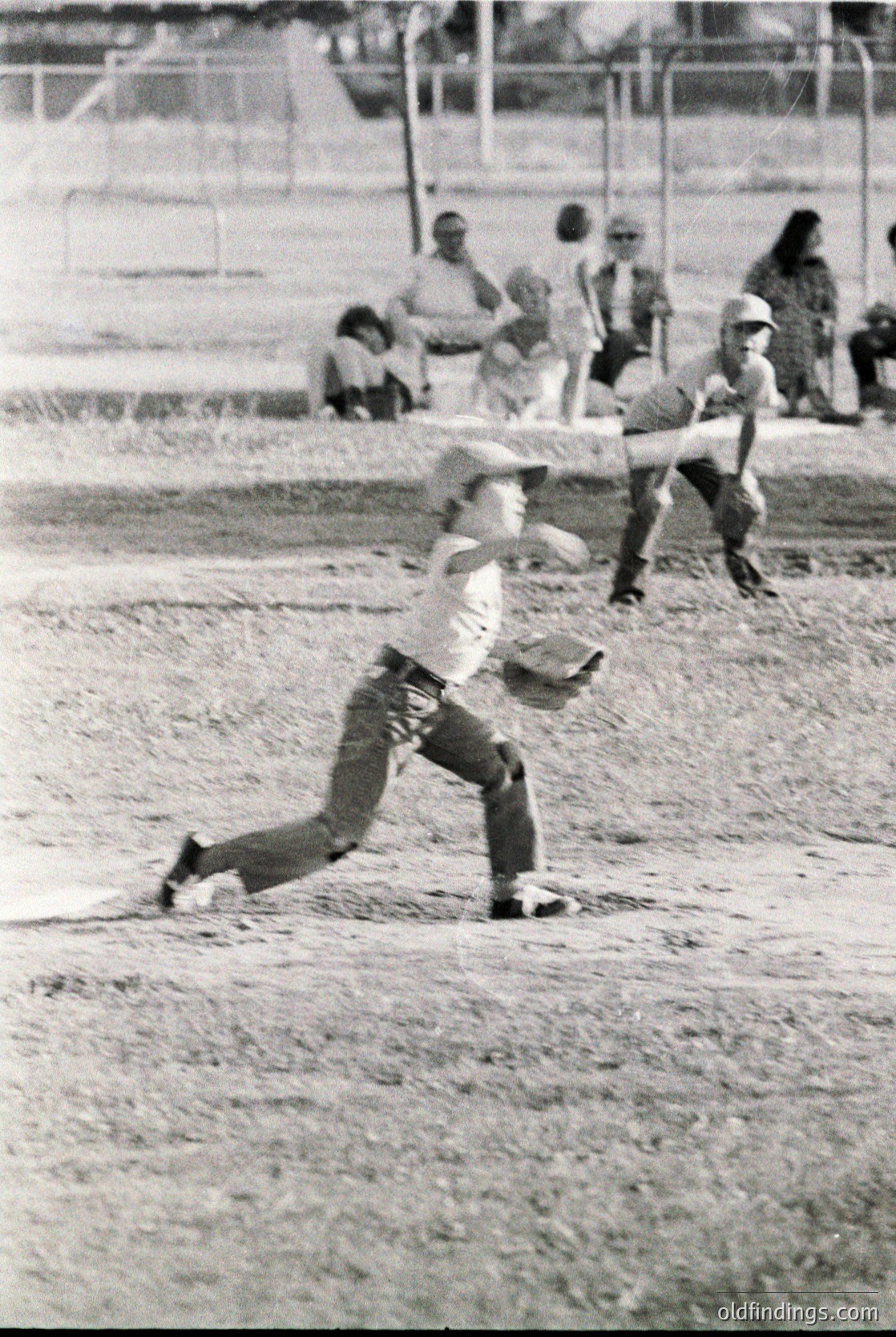 Baseball player mid-slide at home plate, 1960s-70s. Dusty infield, spectators in background. Classic vintage sports action shot.