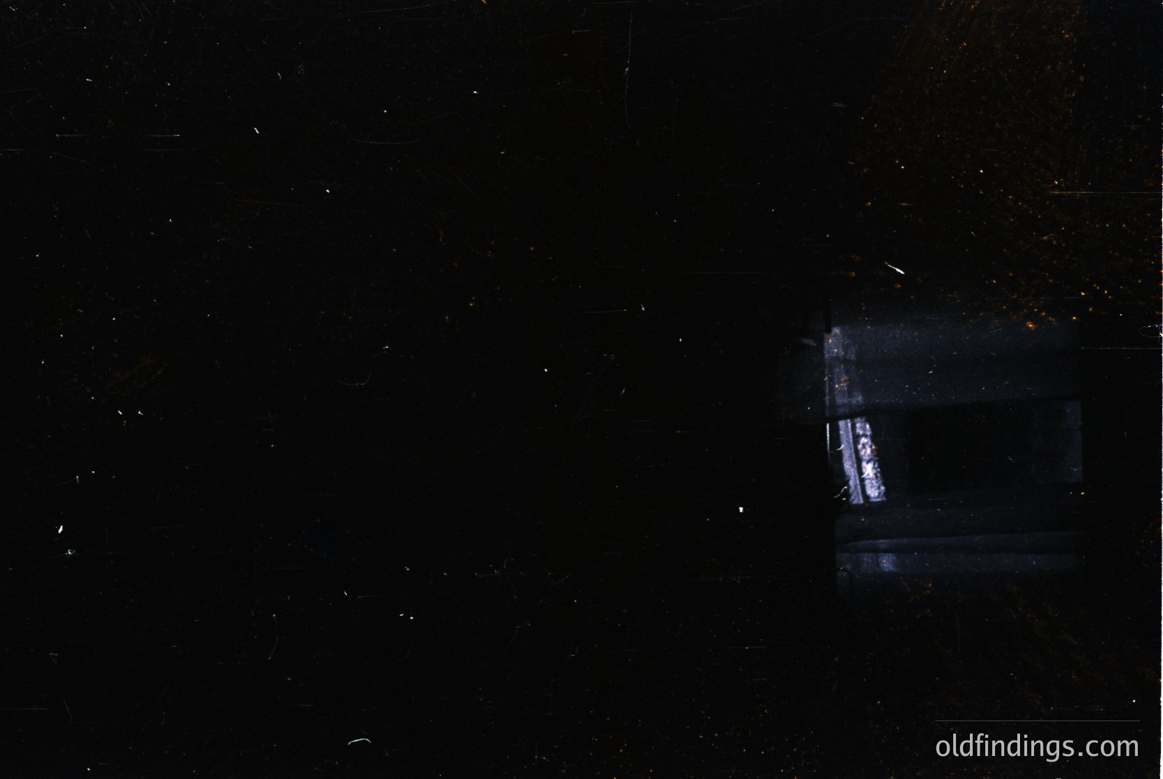 Low-light astrophotography capturing a faint Milky Way with a bright satellite streak. Composition highlights cosmic dust and a distant, blurred artificial light trail. Ideal for space-themed visuals or scientific reference.