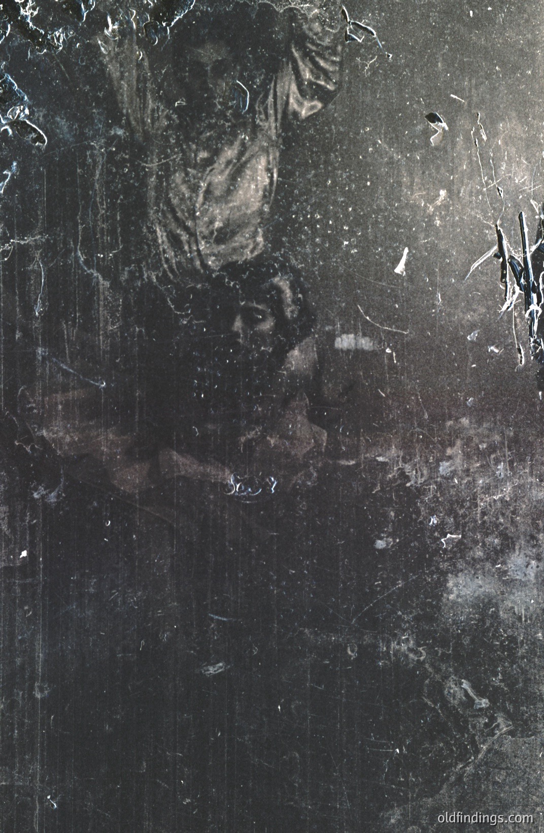 A heavily distressed black and white photograph depicts a figure in dark clothing, seemingly caught mid-motion, possibly dancing or falling. The image exhibits significant aging and damage with scratches, dust, and marks across the surface. Appears to be vintage, possibly early 20th century. Ideal for textural design or vintage-inspired projects.